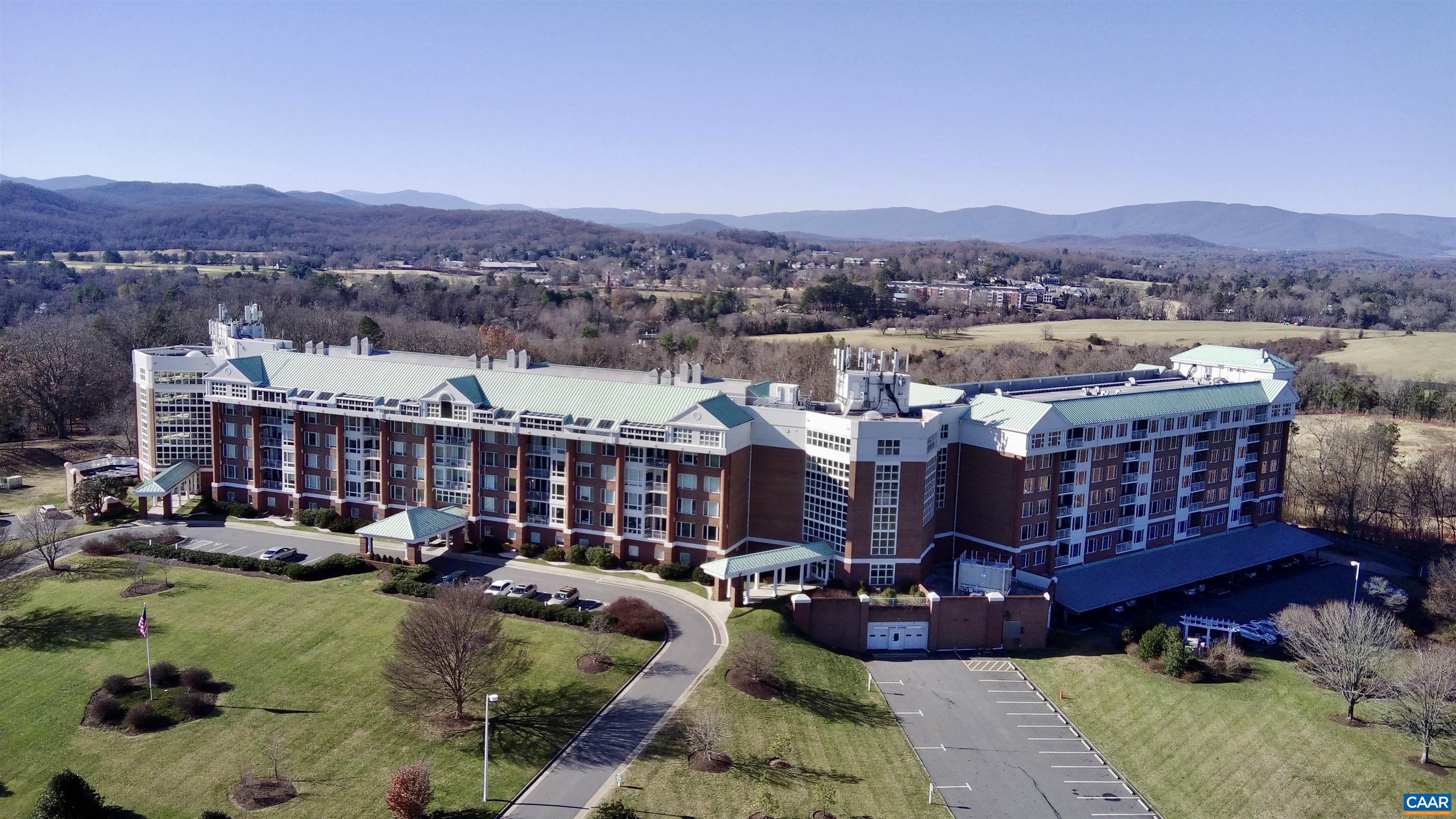 Spectacular elevated and unrestricted views of mountains, UVA campus and Charlottesville from balcony and all rooms of this desirable University Village condo. This condo is a sought after phase 1 East facing unit. Enjoy and relax with unrestricted views 24 hours a day. One level 2 bedroom, 2 full bathroom floor plan with ample storage and closet space with open living room and dining room areas. Hardwood flooring throughout. Updated bathroom, walk in closet and outdoor balcony access from bedroom. Generous pantry space with pull out organizers. Full size laundry room. Fantastic amenities such as guest suites, 6 lane swimming pool, fitness studio, hot tub, dining area, library and more. Don't miss this opportunity! Full motion video and 3D tour links available by request.