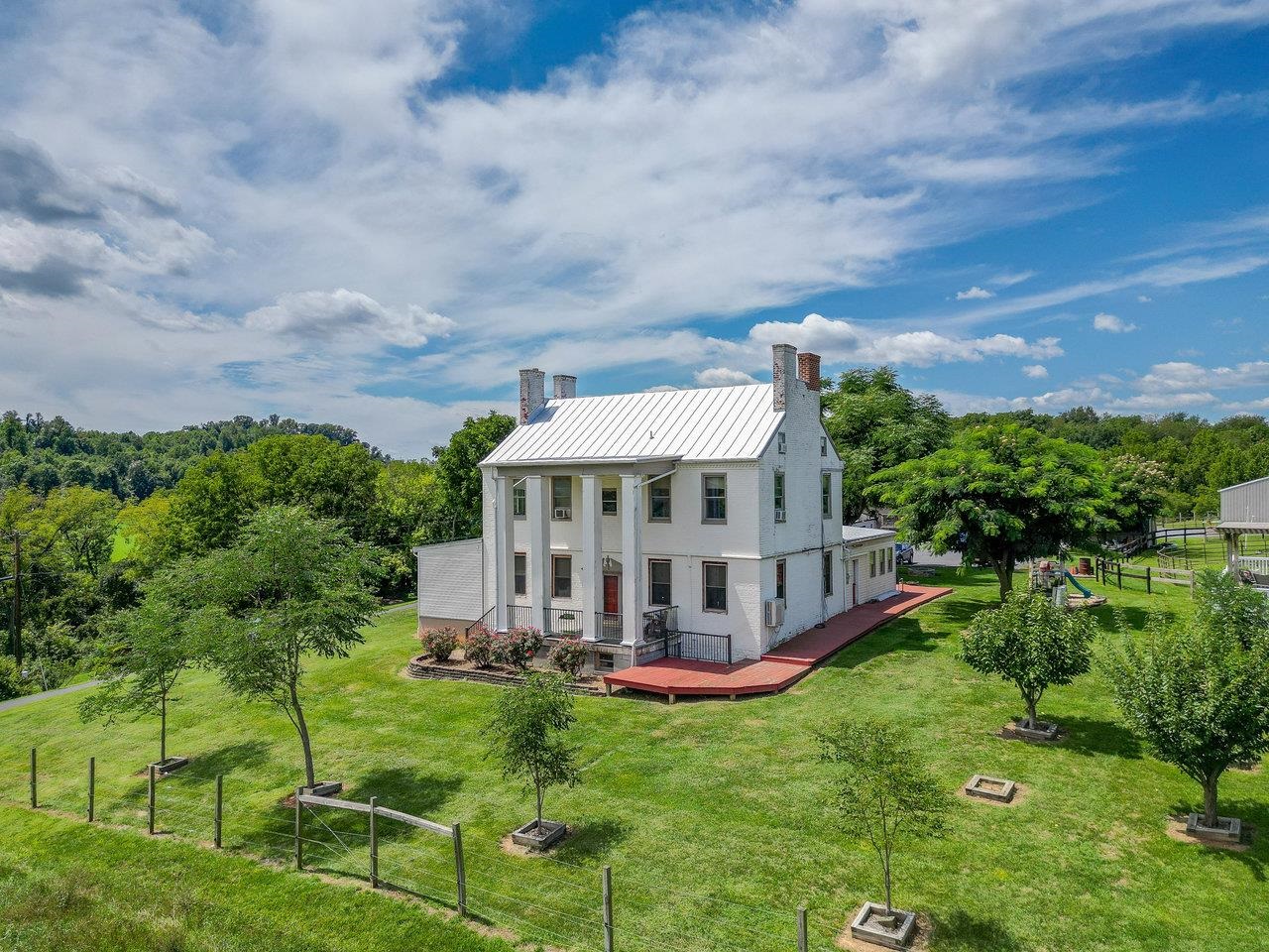 UNIQUE HISTORIC PROPERTY! 22-acre farm located across the road from North River, minutes from Rt 11 and I-81. 5-bedroom, 4-bathroom home, originally built in 1780, features unique details: German-crafted mantle, 18-inch thick exterior walls, detailed finishes. Expansions in 1850 and 1998 blend seamlessly with the home's historic charm. Enjoy river views from the front porch, a ground-level primary suite with a step-in jetted tub, and a second-level primary with custom pine finishes. A finished attic offers additional flexible space, while the basement, with plumbing for a bathroom, could serve as a family or game room. The bank barn provides two apartments (currently under renovation) with ample storage and workshop space, plus five stalls. A separate horse barn features 8 stalls, wash bay, tack room, and ample hay storage. Four hog paddocks, fenced riding trail, and riding ring complete the equestrian facilities. Additional features include a 15x32 ft above-ground pool with a deck and pergola, various fruit trees, and several outbuildings, including a 12 x 16 storage building. A variety of heating and cooling options ensure comfort year-round. The roof was replaced in 2023. ENDLESS POSSIBILITIES!