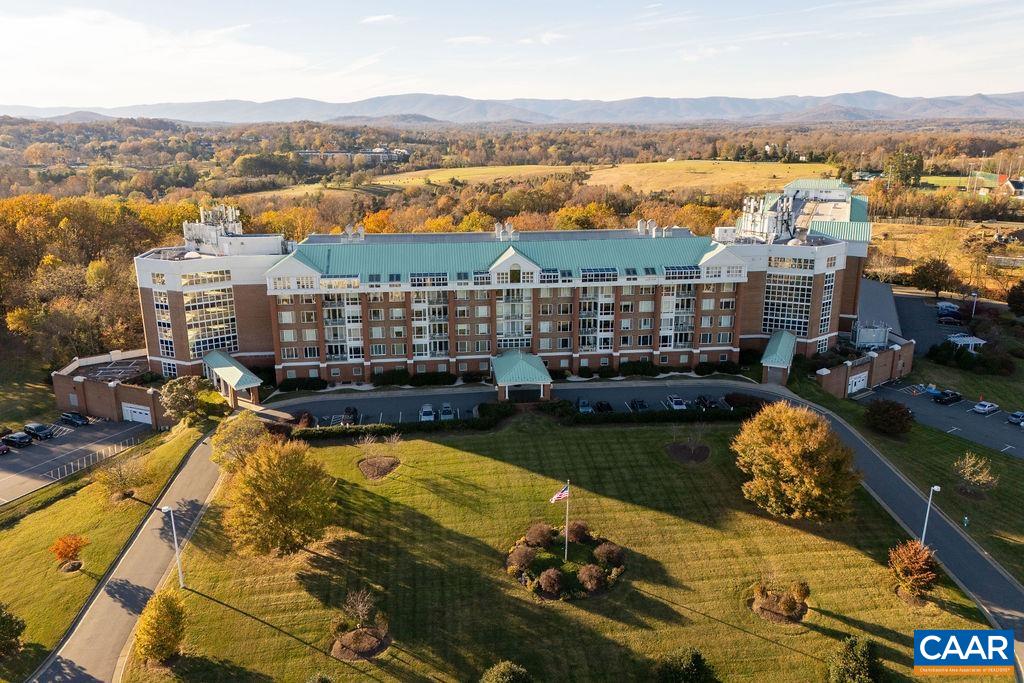 Stunning 4th floor University Village condo featuring 2BR/2BA + Den. Located at the end of the corridor, this west facing unit is ideally positioned for mountain views from every window. This elegant, low maintenance home comes with a dedicated garage parking spot, secure storage & private balcony to take in the sunset views. Enjoy the convenience of a condo fee that covers electricity, heating, cooling, water, sewer, gas, trash, basic cable & access to an array of community amenities, including a year-round heated pool, fitness rooms, library, art studio, LYFT services & more. Fine dining is available 5 nights a week at resident's option. University Village is an active adult community that fosters engagement through well appointed community areas, interest groups & social events. Located near UVA in the heart of Charlottesville, minutes to Farmington Country Club & Boar's Head Sports Club. Small pets are allowed.
