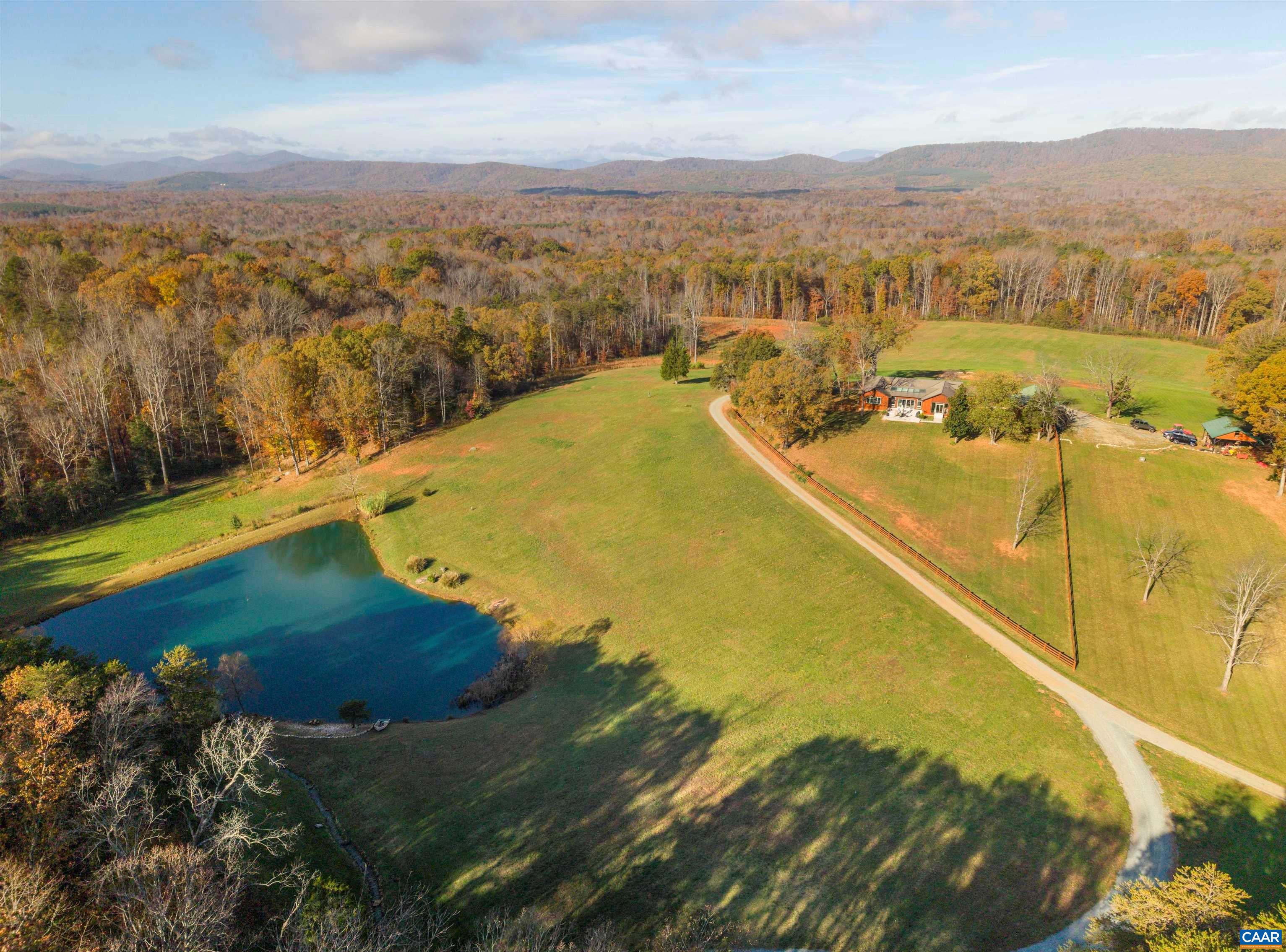 Cedar Ridge is a rare 79-acre estate due to its unique blend of natural beauty, privacy, self-sustainability, and development potential. Nestled in the foothills of the Blue Ridge Mountains, the immaculate turnkey custom cedar home, located at the property’s highest point, boasts stunning panoramic mountain views and an array of captivating water features. With two distinct vantage points, the home offers a serene park-like setting in the back which overlooks two custom waterfalls flowing into adjoining streams before gently spilling into the property's large fully stocked pond. The front offers expansive mountain views and beautiful rolling hills. Other features include numerous trails for riding, hiking, and ATV adventures. Built in 1997 and recently updated, the home offers a spacious split-bedroom layout, gourmet kitchen, and abundant quality natural materials, including custom Pella windows and cedar throughout. A newly built cedar cottage serves as a guest space or potential vacation rental, complete with high-end amenities. With an easy drive to Charlottesville, Cedar Ridge offers everything anyone in touch with nature could want and is close enough to anything anyone could need.