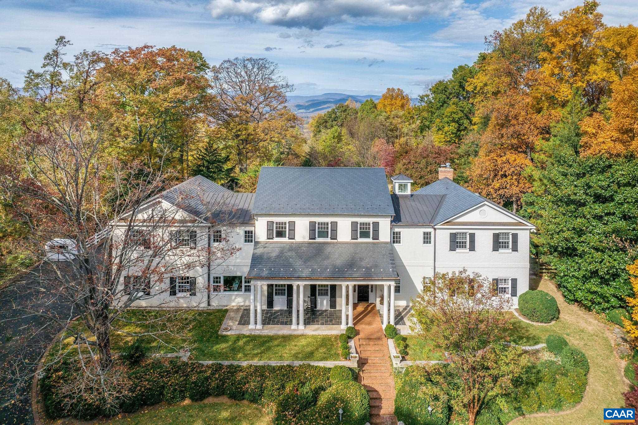 This all brick, stucco, slate and copper, c.1961 residence rests on 1 of the most dramatic, serene, protected sites in close-in, Western Albemarle County. A 14 acre property located just 10 mins to town, in the heart of Ivy w/ truly incredible views.  Panoramic views of the Bl Ridge, Ragged Mtns, Charlottesville & farmland on the way to the Bl Ridge.  These vistas embrace the 5-6 bed, 5 full, 1 half bath home & guest cottage.  Current owners recently completed a comprehensive renovation & expansion. No expenses spared, see details of the renovation in the documents tab.  The approach to this remarkable home is via a paved, gradual ascent. The expansive, dead-level rear lawn could accommodate a pool plus a level, large lawn for kicking a ball. 3 fireplaces incl' outdoors at huge bluestone terrace, 11' ceilings in entertaining rooms. Lovely, private guest cottage/office/studio enjoys views too- central HVAC, conditioned workshop in bsmnt. HUGE estate opportunity in the heart of Ivy.  Firefly fiber confirmed to be installed Spring '25.