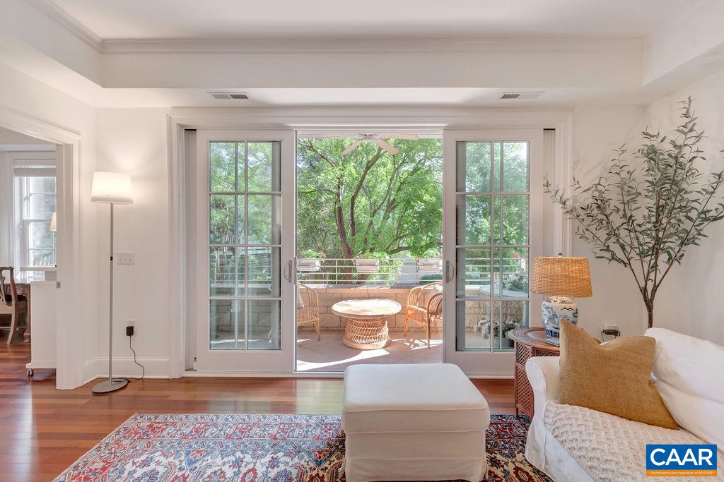 Only a short walk to the historic downtown pedestrian mall, surrounded by local shops and restaurants, live music venues and a health and fitness club, the Randolph is the place to be in downtown Charlottesville. This First floor, 1 bath, 1 half bath condo, offers beautiful custom details including 10' Ceilings, Recessed Lighting, Brazilian Cherry floors, heavy solid interior doors, oversized windows, high-quality sliding doors opening up to the porch, and formal moldings throughout. The open floor design includes an entry foyer, a well-appointed kitchen that opens to a large great room with dining room area, a den/office located off the great room, adjacent to the master suite with private bath. Off the foyer is a hall with a closet for the washer and dryer and a spacious powder room. The covered porch enjoys peaceful Urban city views with beautiful trees and allows for gas grilling. Dues include gas, water and sewer and the condo has garage parking, elevator access and a trash chute on each floor.