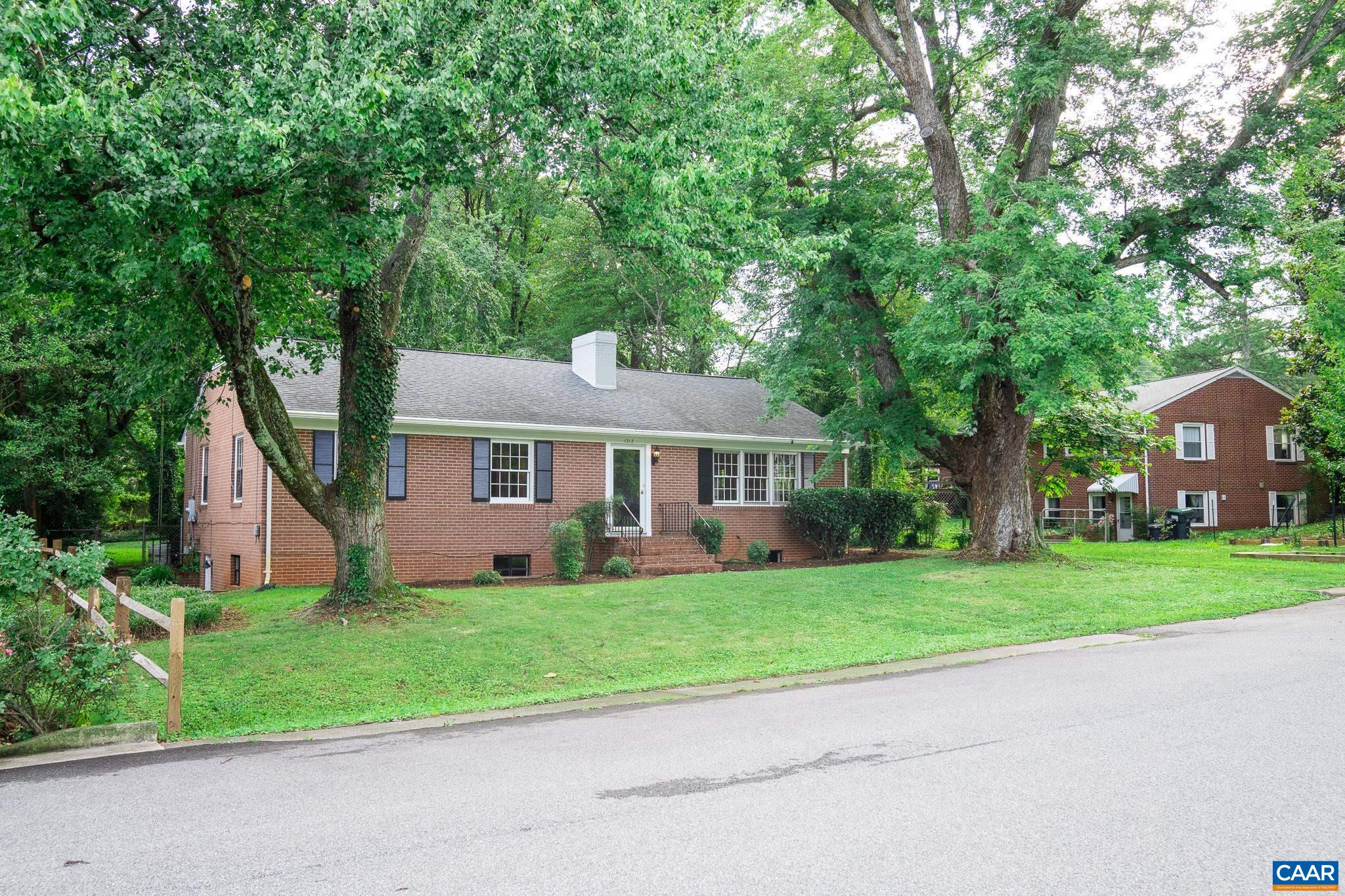 Brick ranch home located in the Greenbrier neighborhood. Walking distance to Charlottesville HS and close to Downtown Mall and UVA. The main level has hardwood flooring, 3 bedrooms and 2 full tiled baths. The vaulted ceiling creates a warm and open living room with wood burning fireplace and eat-in dining area. The kitchen is bright and overlooks the level fenced backyard providing a terrific outdoor space to entertain or enjoy privacy. A partially finished lower level has tall ceiling heights, a fireplace with built in bookshelves, ample storage area and  a separate side door entrance offering new potential to the next homeowner. A great value in a classic Charlottesville location.