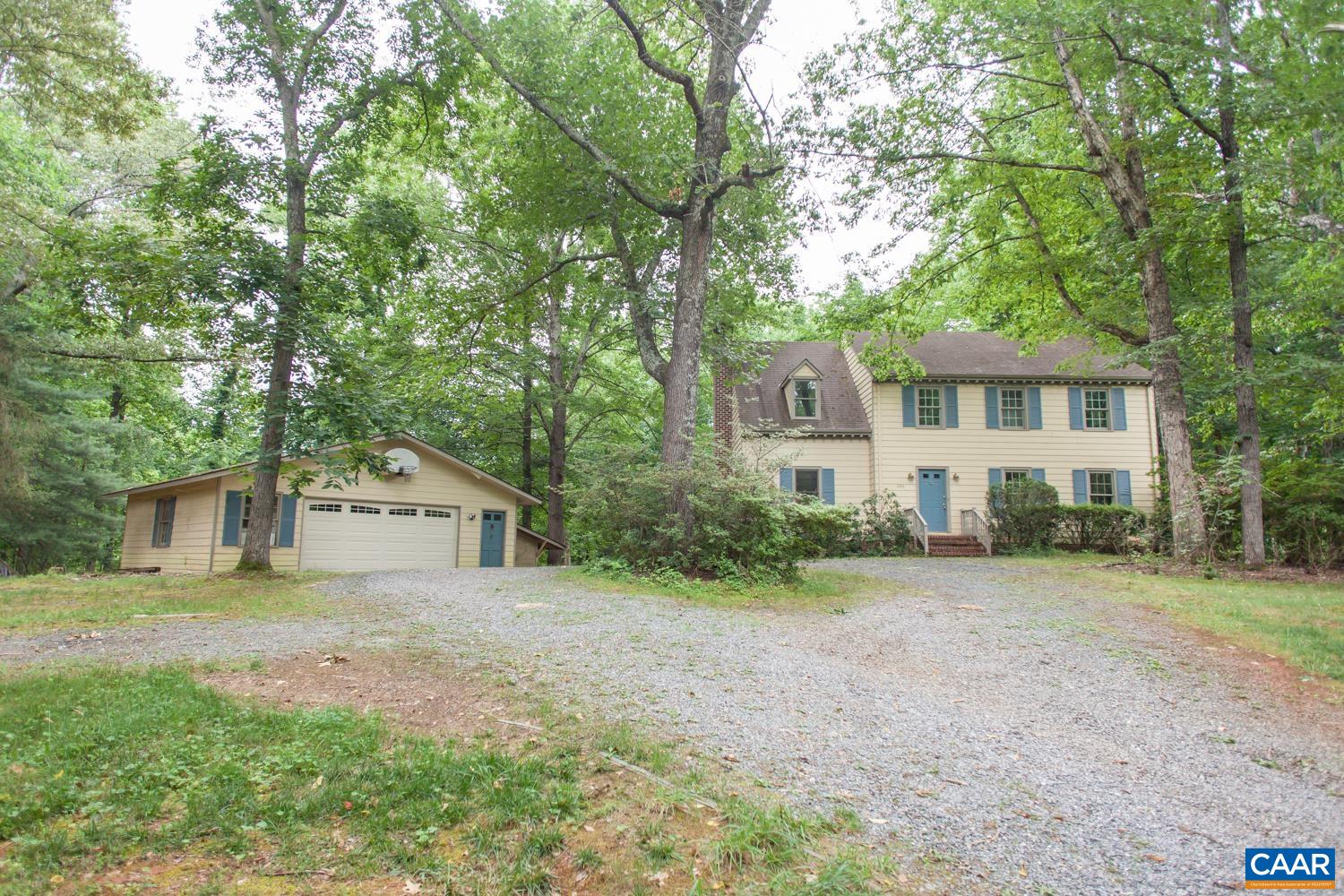 A great opportunity for those willing to invest a little sweat equity to have an  affordable home in the scenic Ivy area! Located near the popular Meriwether Lewis School and just minutes west of Charlottesville and UVA, the location can't be beat. The main level features a generously sized family room with wood burning stove that opens to the eat-in kitchen with new vinyl flooring, and dining room that opens to a large, formal living room off the foyer. Enjoy relaxing or dining outdoors on the expansive deck overlooking the yard with access from the family room. Upstairs, you’ll find three large bedrooms with brand new carpet, a full bath in the hall, and the large master suite with private bath. The walkout basement includes a full bath and space for an additional family room, bedroom/study. As a bonus, there is an oversized, detached 2 car garage with plenty of space for a workshop, storage, or hobbies PLUS additional workshop/studio spaces on the property. With 1.3 acres of land there is ample room for gardening, outdoor living, and entertaining. Don't miss this opportunity!