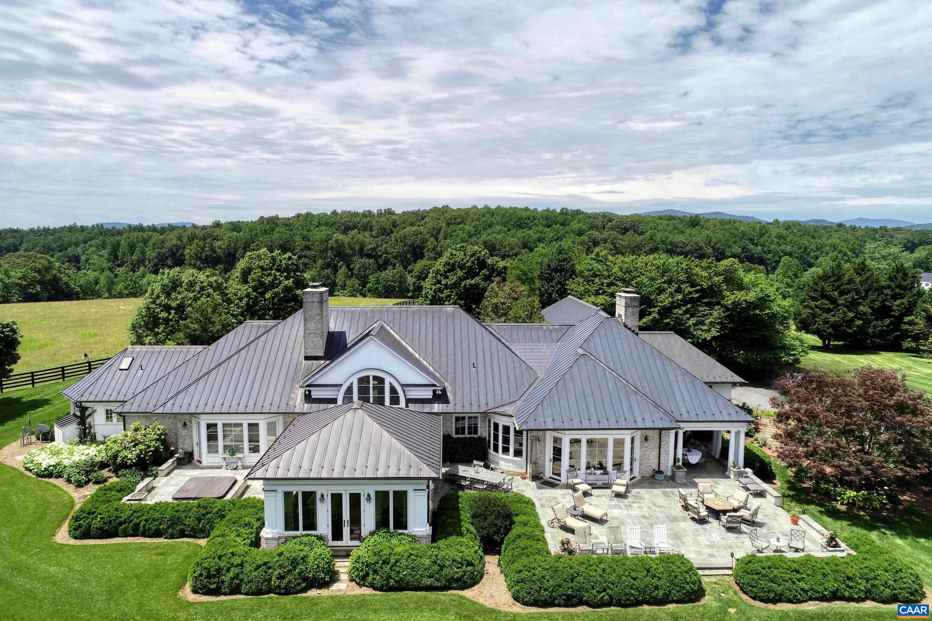 Exceptional estate less than 15 minutes south of Charlottesville.  The elegant residence is perfectly sited for views of the surrounding Ragged Mountains and a 30-acre lake with private dock, while also providing complete privacy.  Constructed by Shelter and Associates, the home features superior craftsmanship and materials, including custom mahogany cabinetry, inlaid oak flooring and a barreled ceiling.  From the interior, large casement windows and french doors bring in the natural beauty of the North Garden surrounds.  Outside, large patios with fireplace and outdoor kitchen are the perfect setting for entertaining.  Also featured are an attached, car-enthusiast's 3-car garage, geothermal HVAC, a whole house generator and a separate two-car garage with living quarters.   A private estate, 15 minutes from Charlottesville and the University.  A beautiful home.