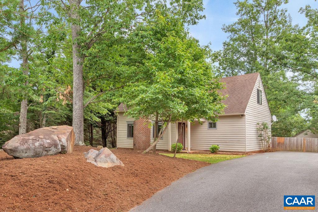 This is a renovated home with an open floor plan on a quiet cul-de-sac in Mill Creek South. The kitchen, with stainless steel appliances, granite countertops, white cabinets, and tile backsplash, is terrific. There is a first-floor primary bedroom, which could serve any number of other purposes, living room with wood-burning fireplace, and sliding doors that open onto a stone patio. There are three bedrooms upstairs with a full bathroom. The home was built by Craig Builders. The back yard is fully fenced and includes a large storage shed. The front yard features large rocks, which are both a neat, unique feature and zero maintenance. Enjoy proximity to Wegmans, I-64, UVA, downtown, etc. This property is remarkably private thanks to mature landscaping.