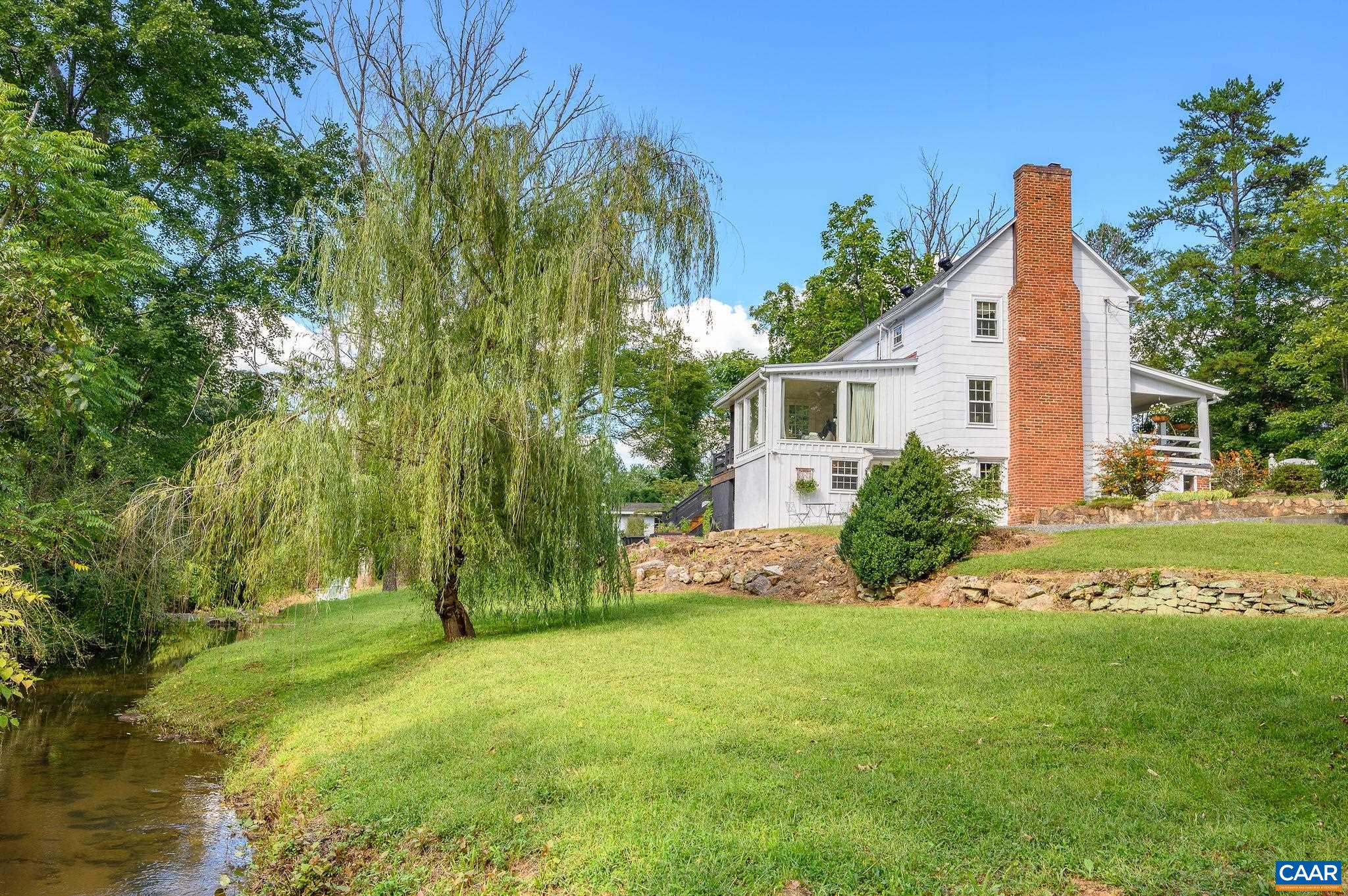Welcome to the Crossroads Miller’s House - a magical country farmhouse whose light, bright, renovated aesthetic seamlessly complements the endless original charms. Constructed in 1821 and nestled among other well cared for, vintage homes on a lovely stretch of Plank Road in the village of North Garden, just moments to the quick access to town that 29 South offers. You will delight in the exposed rough-hewn timber walls, original ceiling beams, 12 inch plank board flooring, exposed brickwork and painted stone foundation. Interior designer-owner has continued to improve & meticulously maintain this idyllic country property with design and renovation choices that have continued to enhance the appeal of the original structure. What once served as the original barn has been converted to an enchanting jewel box guest cottage/studio/office overlooking the meandering creek that borders the property.