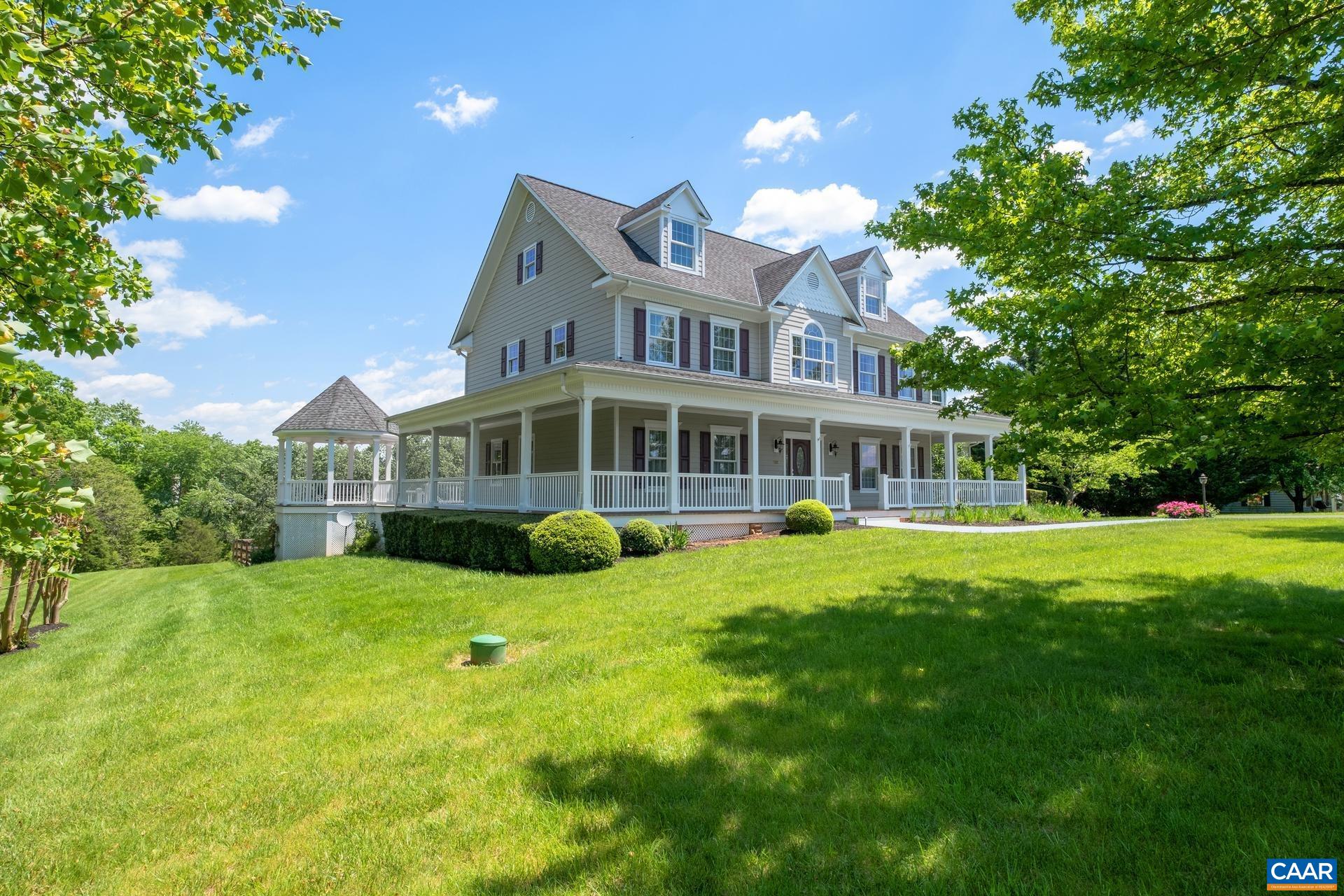 Year round views come with this 5 bedroom 5 bath home. You won't find a better porch/deck/gazebo to sit and enjoy the views or to throw a BBQ/pool party!  Open family room and gourmet  kitchen. Family room has a 17 ft high ceiling, gas fireplace and easily steps out to the deck for a cookout.  The kitchen has a gas range, double GE convection/microwave oven, cherry cabinets, granite counters. Hardwood floors throughout the main level, tray ceiling and recessed lighting in the dining room. The owner's suite has a gas fireplace and wonderful bath with heated tile floor and jacuzzi tub. The office attached could be used as a nursery. The lower level is finished as an office but you could create a home theater or exercise room.   The garden soil is in great condition after being worked for 9 years. producing delicious vegetables last year.   A quick 8 mile drive to medical care, shopping and restaurants at the corner of RT 29.   Very convenient to the Airport.  You will find the peace and quiet of the country here without being too remote.