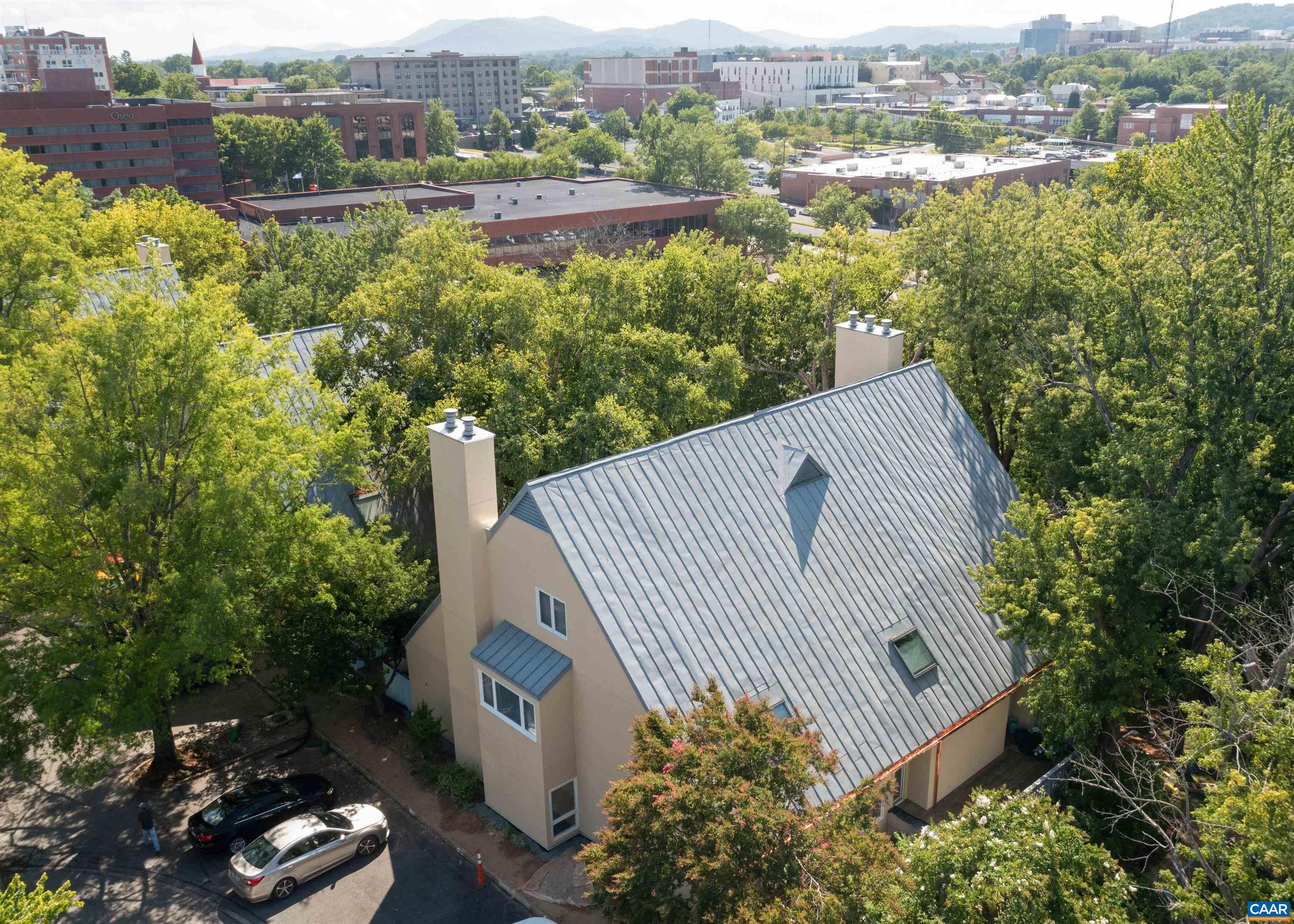 MCGUFFEY HILL - Terrific, spacious first floor living within seconds of the many amenities of the Historic Downtown Mall. The 2,194 finished square foot residence comprises a large bright living room with fireplace, kitchen with generous counters and cabinetry along with a breakfast area, dining room, master bedroom and bath, second bedroom which is flexible space for office/library/media area and adjacent full bath and laundry/utility/storage. Many custom features such as updated large master closet built-in system and built-in bookcases. A new Trane Heap Pump. Enjoy the outdoors from two balconies. Privately situated with easy access to the reserved parking. Great opportunity to have convenient, spacious downtown living!
