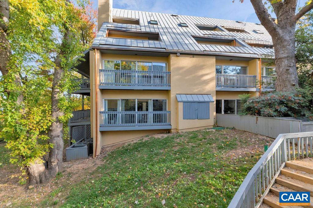 JUST 2 BLOCKS TO THE DOWNTOWN MALL in the desirable MCGUFFEY HILL community adjacent to the McGuffey Park + Art Center! An OASIS conveniently located in the heart of the city, this END UNIT CONDO overlooks a grassy common area + mature trees from its many windows + gracious COVERED DECK.  Enter an updated foyer w/ modern 12x24 tiles + coat closet, leading to the crowning jewel: a huge living area w/ gleaming hardwood floors, wood-burning fireplace + wall of built-ins. An updated kitchen feat. granite counters + opens to a breakfast nook w/ a treehouse feel. The bedroom is a great size + tucked away from the living area yet near the RENOVATED BATHROOM, complete w/ a new marble-top vanity+ fresh white tiles, + laundry room. Exterior painting underway in the neighborhood + it looks fantastic!  Location, location, LOCATION - this condo offers all that is the vibrant Downtown LIFESTYLE - restaurants, theaters, music, art + more!
