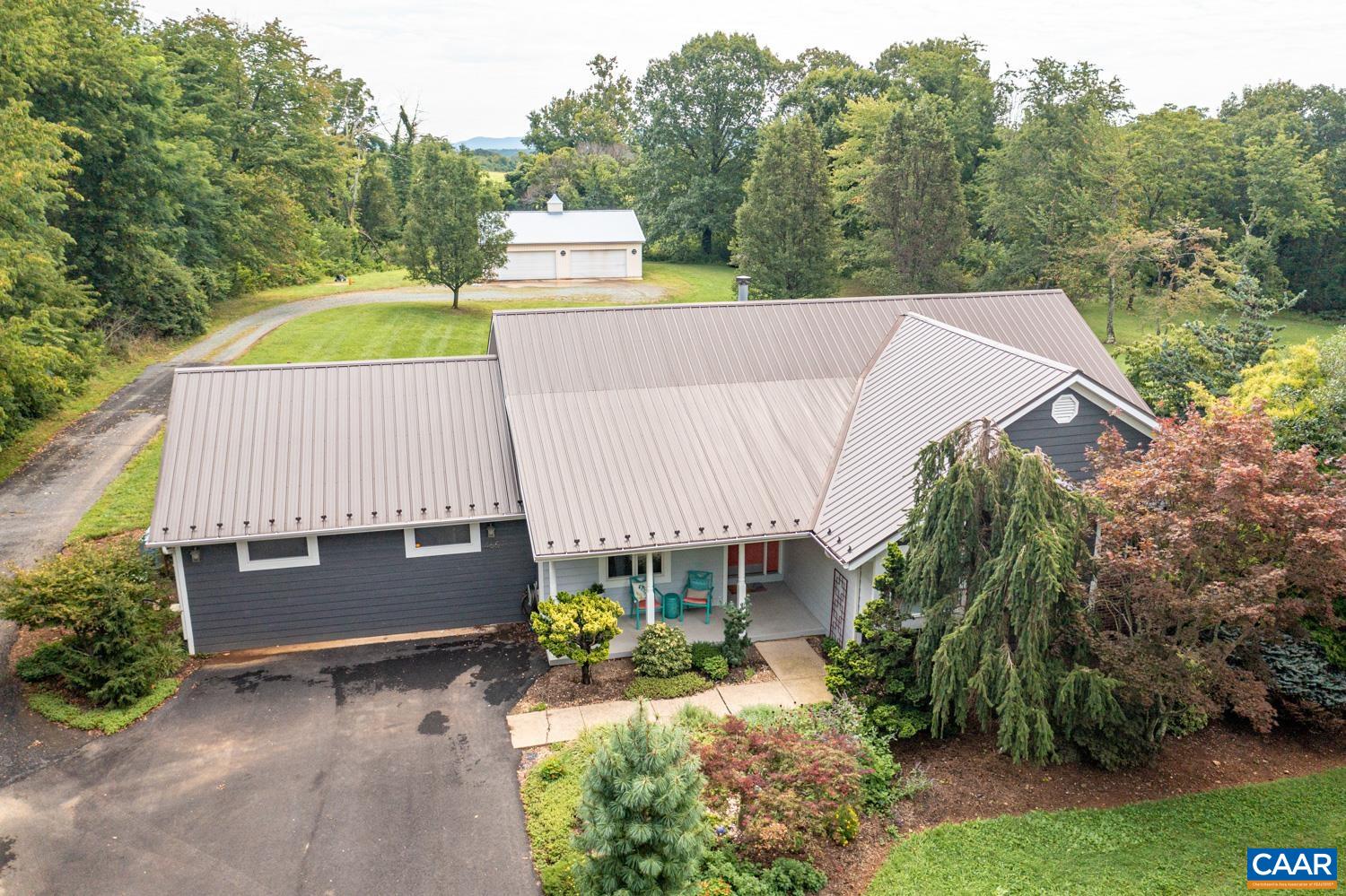Welcome to 465 Newtown Rd.! A beautiful 4BR, 2BA, one level home, situated on a serene 2.19 acre lot, with a massive 1760 ft.² 8 car garage/workshop and located in desirable Albermarle County. As soon as you pull in the driveway, you will notice a charming little bridge, inviting gazebo, a beautifully nurtured lawn and be able to envision yourself sitting on the covered front patio sipping coffee each morning. Upon entering, you will feel at home with the meticulously maintained and wonderfully updated open concept living that this home offers. With a gas log fireplace, stunning built-ins, butcher block countertops, hardwood floors, tile baths, whole house generator, metal roof, a large master bedroom w/ en-suite bath, a walk in closet, plus an even larger 4th bedroom that can also  be used as a bonus room, playroom, gym, large office etc. with plenty of storage(3 closets!). You will never be short on things to do with gorgeous scenery, nearby wineries, vineyards, orchards, historical locations, national parks, shopping and so much more. Price reflects recent appraisal!