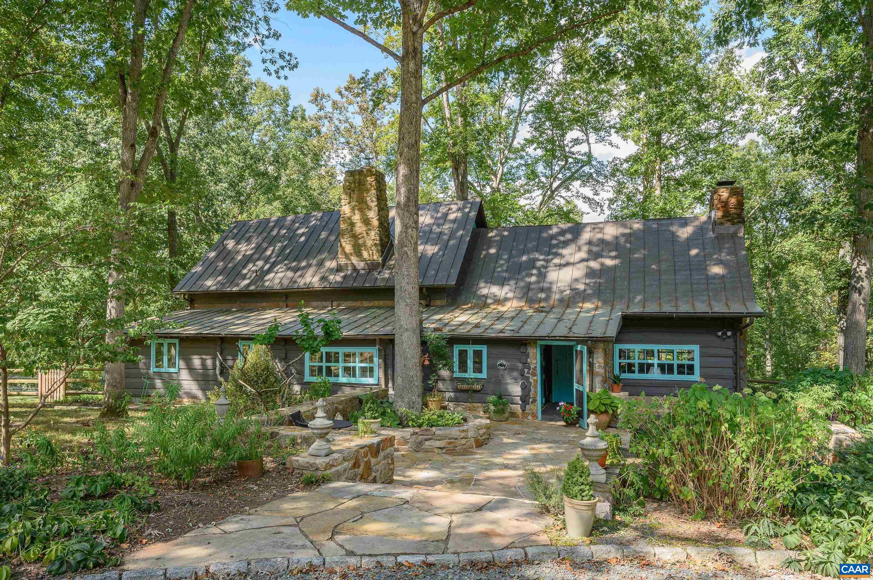 Guaranteed, this remarkable c. 1930 cottage tucked away in Keswick yet just mins from Downtown, will steal your heart w/ its endless charms, privacy & history. The vaulted great room is light & airy, even as it is framed by a massive stone fireplace w/new wood stove. Soapstone counters w/ painted white cabinets & built in pantry in the kitchen complement exposed beams. The untouched cabin walls in the living room, w/ another stone fireplace, provide the perfect counter point to the white washed great room. Screen porches on both floors bring the outside in. Massive hardwoods shade expansive, level lawns w/ studio space. A rare find with 2 parcels. Who knew this well loved, historic gem was here on over 8 acres, in Keswick Estate?!