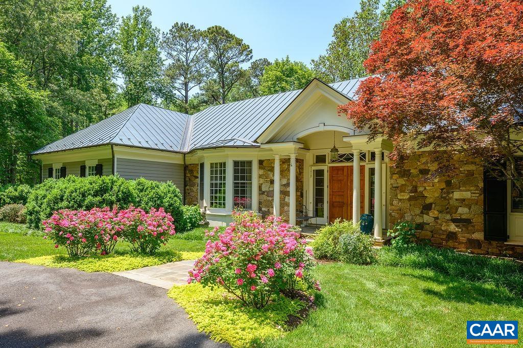 Magnificent custom residence on over five acres, 8 minutes to Barracks Rd shops & Farmington CC. The home features finest quality materials & finishes, including exquisite crown molding & heart pine floors, copper roof & gutters, high ceilings, and a creative blend of formal and informal spaces. This traditional Virginia home, with stone & painted cedar clapboard siding, was designed in 1991 by noted architect Henderson Hayward and built by master craftsman John Anderson. The spacious first-floor master suite with two master baths and walk-in closets, four fireplaces, updated kitchen, generator, & 800-sq.-ft. unfinished second-floor bonus space are just a few features the new owners will appreciate. Beautiful, fully landscaped homesite, comprising a wonderful variety of perennials, flowering shrubs, ornamental trees, boxwoods, and mature hardwoods; and highlighted by a stunning, low-maintenance, four-falls water garden with fishpond, all protected by a one-acre deer fence and automatic-open driveway gate. Borders the 175-acre Foxfield property, in conservation easement, with long pastoral views to the Blue Ridge mountains. First time on the market in 24 years and first listing on this secluded country lane in more than a decade.