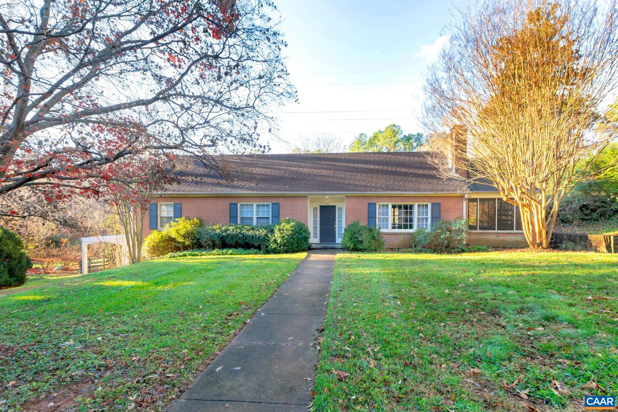 Well-built brick residence in need of updating with a convenient location adjoining McIntire Park and in close proximity to Walker Middle School and Charlottesville High School. This home features a large spacious living room with fireplace that is open to the dining room.  There are beautiful hardwood floors throughout the main level. The screened porch on the west side of the home leads to a large sunny soapstone terrace with wonderful southern exposure. The expansive yard is level and open with large mature trees and a storage shed. The full basement with two bedrooms has access to the carport with room for 2 cars and 2 storage closets. The attic is floored and offers the potential of designing additional living space within the footprint. This city home has tremendous potential.