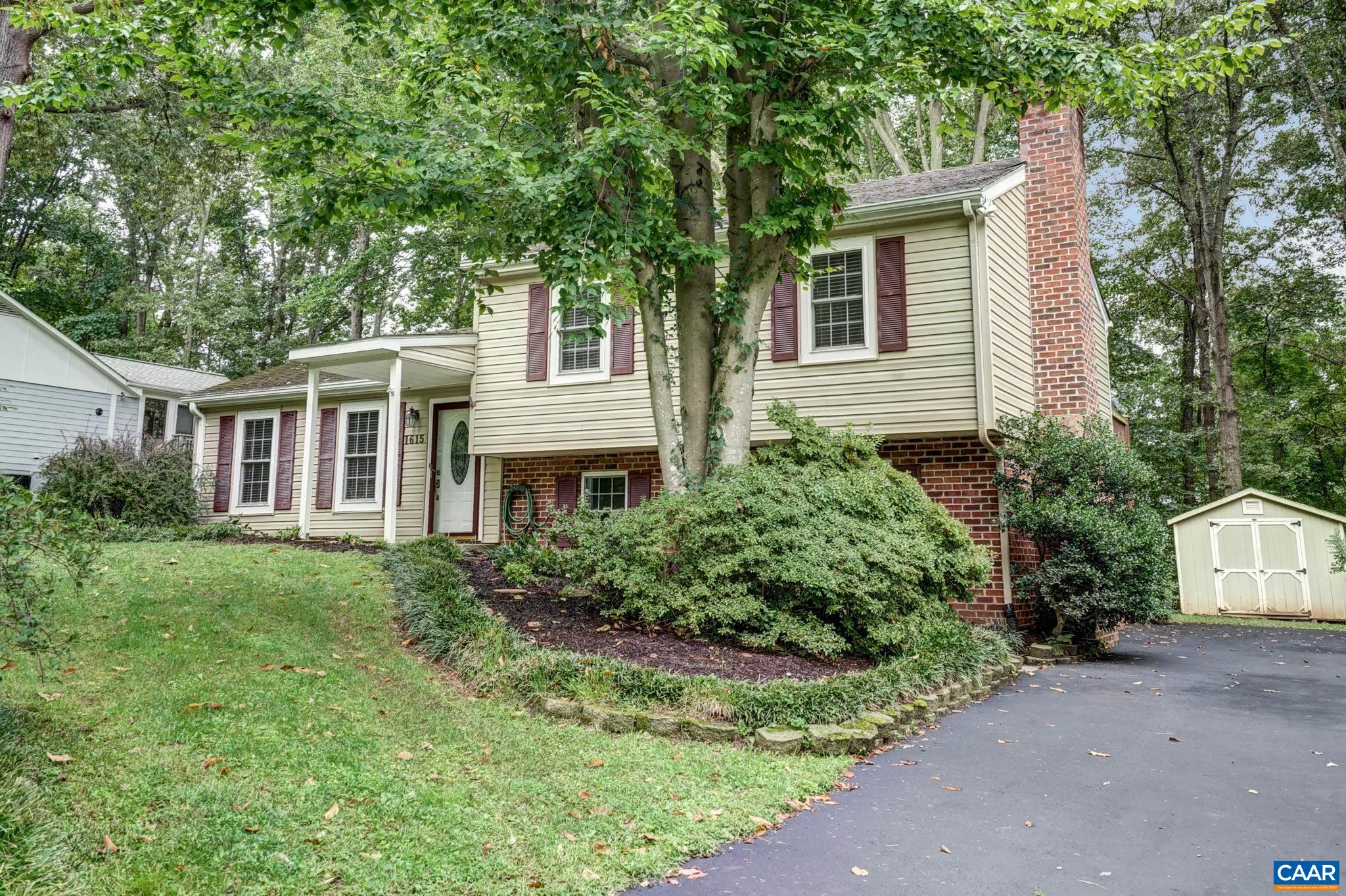 This charming split-level home in the popular North Charlottesville neighborhood of Hollymead is a must-see! You'll love the location within walking distance of local schools, and minutes from Target, NGIC and route 29. With fresh paint and new hardwood floors this home feels bright and cheery. The main level features a large living room, formal dining room and kitchen featuring oak cabinets, updated appliances and a tile backsplash. Upstairs the primary bedroom features a private bathroom and two additional bedrooms which share a hall bathroom. The lower level features a large rec room with brick fireplace, large utility room and a full bathroom. Entertain outdoors on the large patio or rear deck with access to the primary bedroom! Freshly paved driveway and storage shed too!