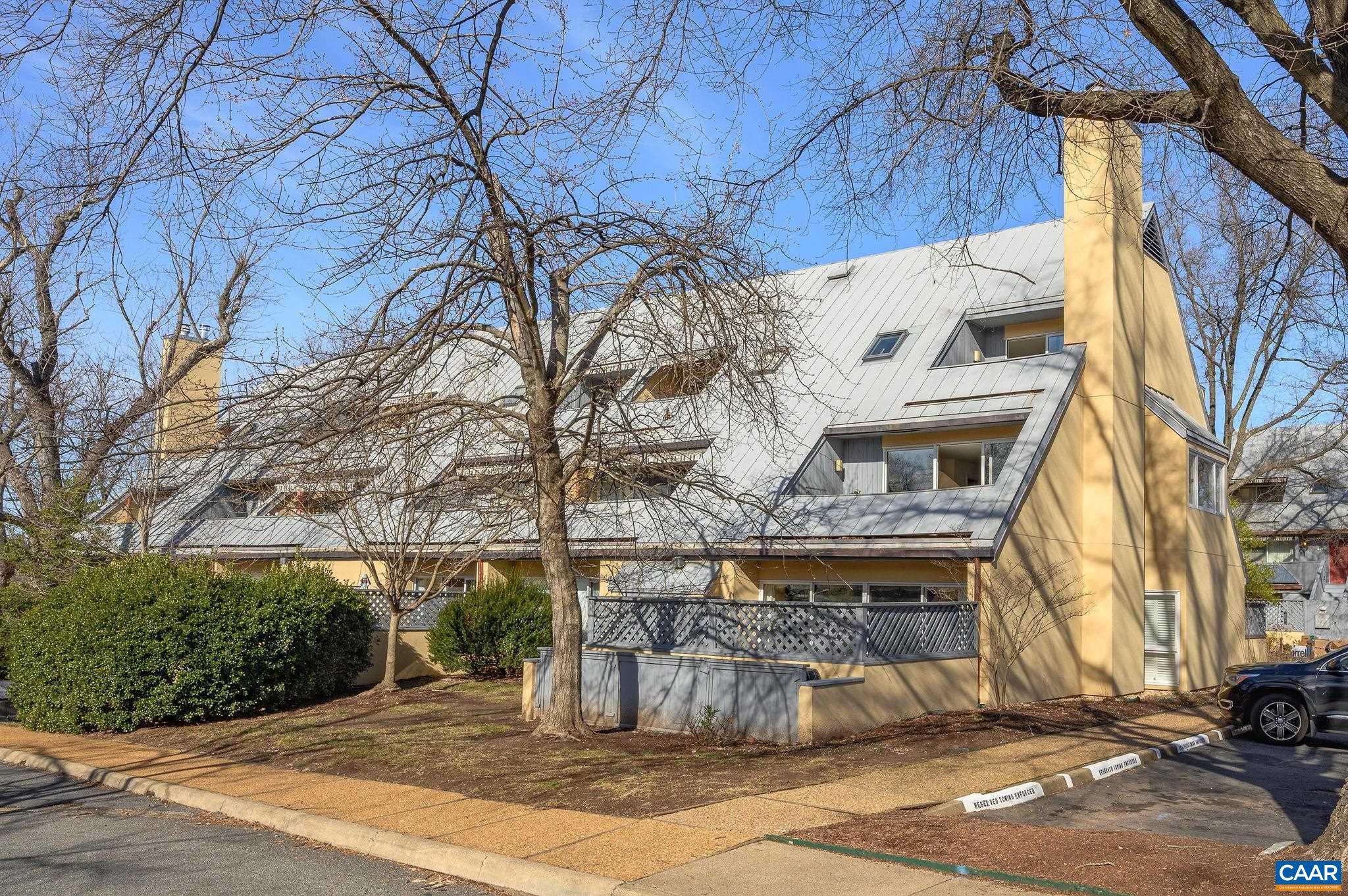 Beautiful condo located one block from Charlottesville's historic downtown mall, adjacent to McGuffey Art Center and McGuffey Park. A short stroll to restaurants, theater, entertainment, shopping and more. Located in a prime south facing location away from busy streets, this end unit townhouse condo boasts a Karen Turner designed kitchen, fireplace and covered parking. Open plan, infused with natural light from dawn to dusk. Enjoy the decks adjoining the living area and primary bedroom. The south facing primary suite features a tiled bathroom, laundry,  abundant closest space and ample storage. The second bedroom is perfect for an office/guest room. 200 sq. ft. floored attic. Vacant, freshly painted, carpet shampooed, this condo is ready for a new owner. Parking for 2 cars. One is a designated covered space.