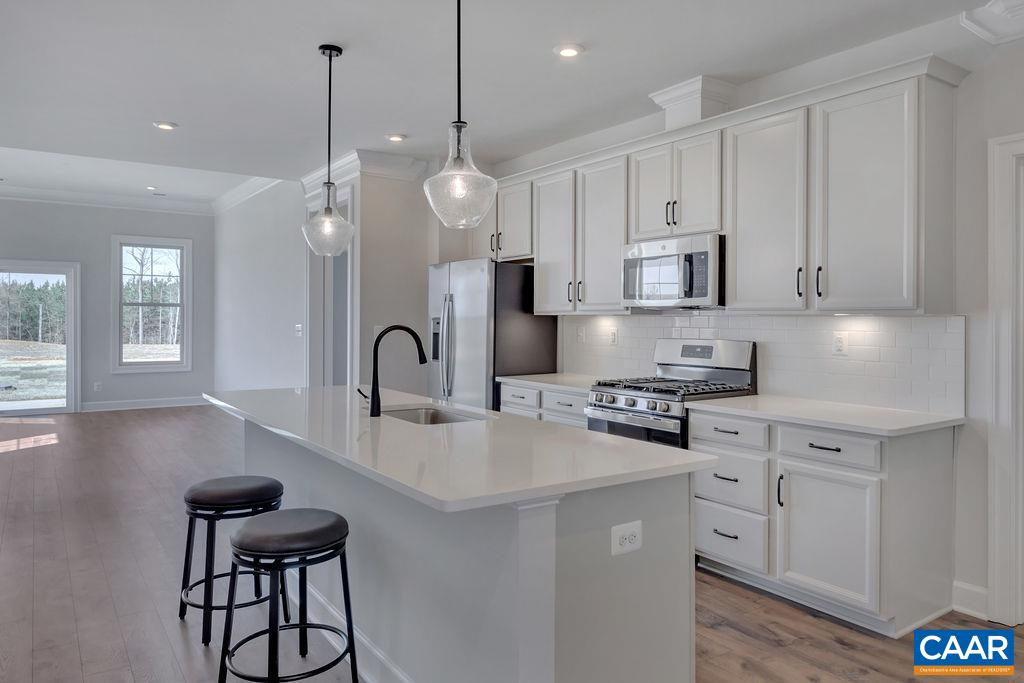 This is one of the last remaining homes in the highly desirable Parkside neighborhood! Don't miss your last chance to live walking distance to Downtown Crozet and steps to Crozet Park. This main-level living,  low-maintenance home has a zero entry 2-car garage which makes bringing in groceries to your kitchen a breeze. The huge island with counter seating, plentiful white cabinets, and quartz countertops is every chef's dream. Entertaining is easy with the intuitive room-to-room flow from the dining area to the light-filled family room. Extend your living space outdoors to the private 10'X14' patio. A sizeable primary suite is tucked away on the main-level in the rear of the home and features generous closet space, huge windows, and 10' ceilings. The second floor is built with two bedrooms, a full bathroom, and a second living space that makes a great home office, playroom, workout area, or hobby space. Neighborhood amenities like a firepit, trails, and swinging benches offer places to unwind within the community. Glenbrook at Parkside has it all! Photos shown are from a similar home. This home is currently under construction with an estimated delivery of Spring 2023.