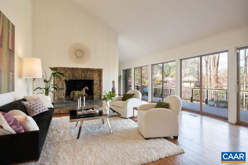 Rare opportunity to own a Mid-Century Modern gem in coveted Colthurst Farm, popular for its lovely, peaceful setting & ULTRA convenient location - minutes to Barracks, Stonefield, UVA & downtown. This home has all the classic elements we love about MCM architecture - open floor plan, clean lines & large windows designed to "bring the outdoors in." The dramatic, vaulted living room features a beautiful stone, wood-burning fireplace, hardwood floors & oversized windows overlooking the gorgeous backyard. The stunning dining room includes modern new lighting, vaulted ceiling & more windows overlooking the views. An impressive Trex deck spans the entire back of the home & provides the perfect place to gather & enjoy elevated views of blooming trees & distant mountains. The main level primary suite includes a delightful sitting area w/ floor to ceiling windows & attached bath w/ low-entry shower. Easy-living main level also includes a sunny home office & convenient laundry/mudroom off the kitchen. Wonderful walk-out terrace level provides 2 large bedrooms (one could also function as a family room), full bath, kitchenette & 2.5 car garage. If you're looking to put your mark on a Mid-Century classic in a premier location - this is it!