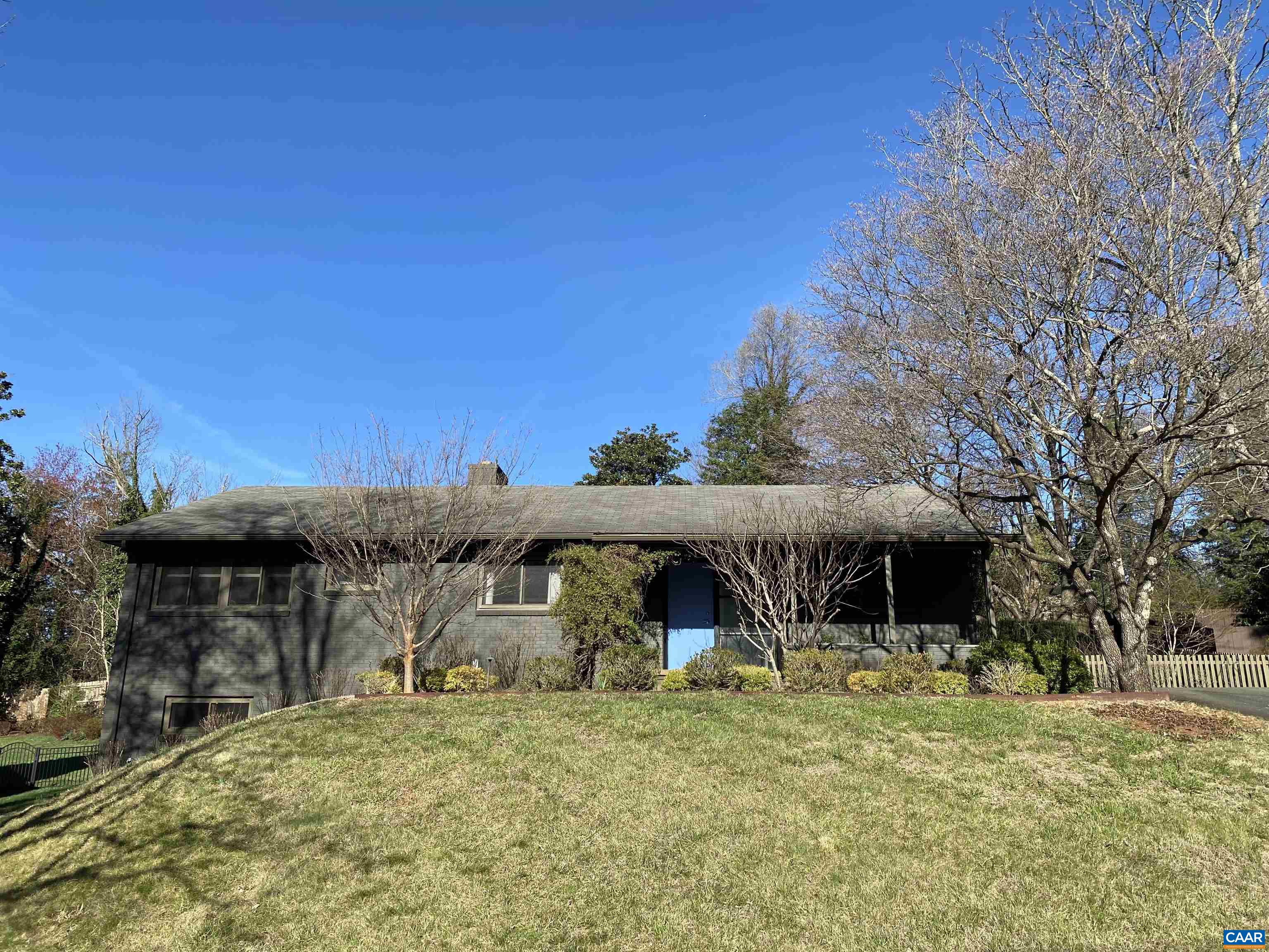 Exceptional design highlights this extraordinary home, with its clean lines, floor-to-ceiling windows, and seamless transitions to the outdoor spaces that complement the highly functional and sophisticated residence. The kitchen boasts a professional-grade gas range and oven, Brazilian slate counters, custom butcher block, mahogany shelving, paneled and counter-depth refrigerator and dishwasher, thoughtful cabinetry systems, and an integrated wet bar. Brand names include Blue Star, Blanco, Madeli, and Bosch. Bask in the brilliance of the large, bright living room that includes one of two wood-burning fireplaces and looks out onto a storybook back yard. The grounds feature a screened pavilion with cedar shake siding and Canberra hardwood flooring, grill island with sink and dedicated gas line, and bluestone patio. There are three crepe myrtles, a fig tree, and a Japanese maple in a showstopping concrete planter. There is a finished basement with ample storage and room for the creation of an additional bedroom. Bathrooms have been remodeled, and window treatments and recessed lighting have been added. This property is in the center of C-ville with incredible access to multiple parks, trail systems, downtown, and UVA.