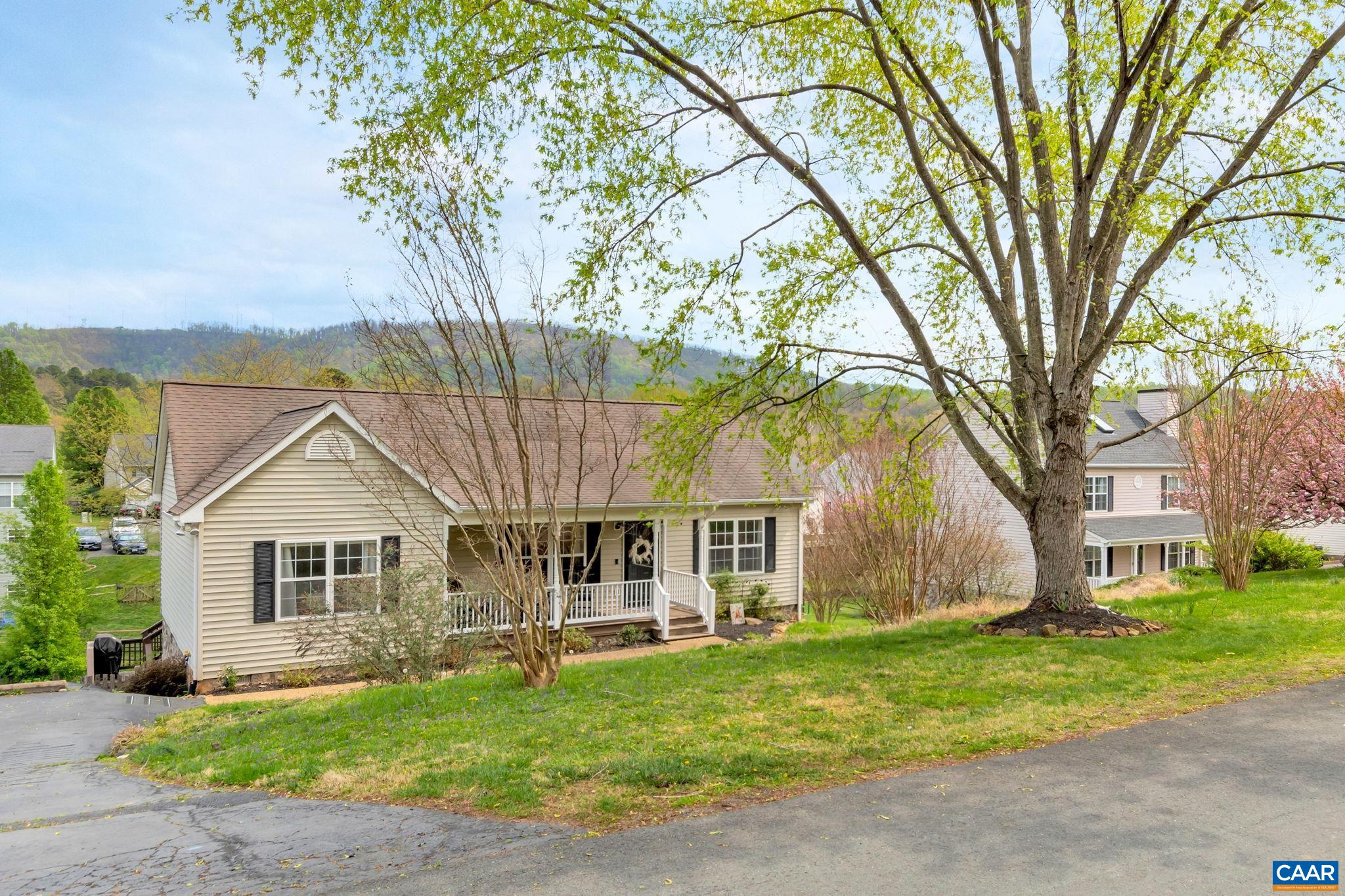 Enjoy a mountain view from the privacy of your screened in porch tucked away in a peaceful amenity rich neighborhood just minutes to groceries, UVA medical center, Interstate 64, downtown CVille and the Biscuit Run trail system. This 3 bedroom/2 bath one level living home has a large open concept living room to kitchen with a vaulted ceiling, hardwood floors throughout, ceramic tile in bathrooms, a screened porch on the back and a covered porch on the front both spacious for relaxing/dining or entertaining. Fully fenced backyard. Master En-Suite is anchored on one end of home and 2 guest rooms with full bath on other side. The HVAC (heat pump) was replaced in 2022, updated lighting, updated plumbing fixtures, custom paint color on kitchen cabinets, new hardware and overall a well maintained home. The Lake Reynovia neighborhood includes a pool, tennis courts, clubhouse, play area and a lake to explore! Huge storage space under screened porch. Easy living in a great location. Fiber Internet available and 30 day Closing Possible! OPEN SUNDAY 4/16 from 1-3 pm.