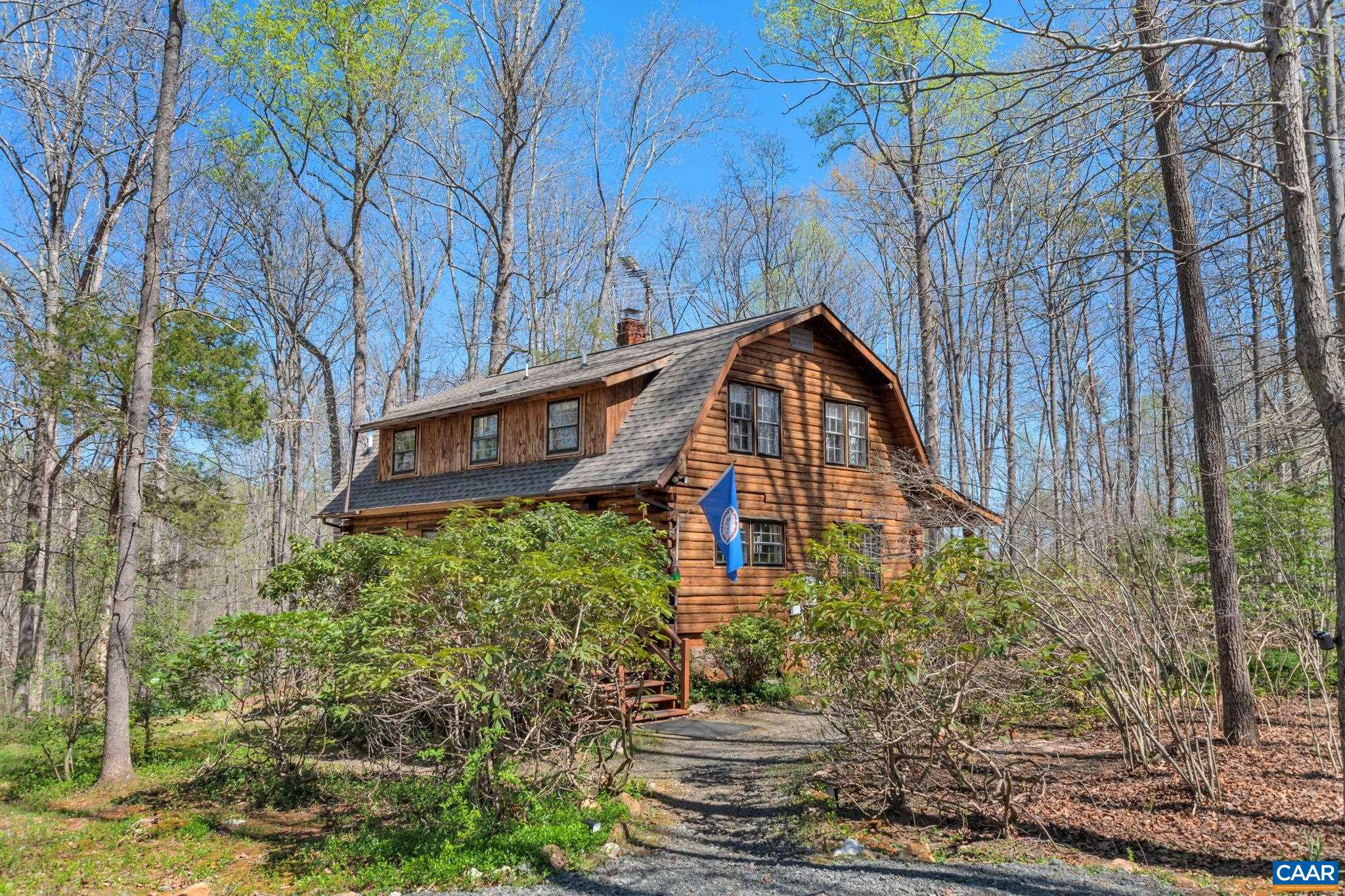 This charming home has been totally renovated adding a contemporary flair to a log cabin home. New fireplace & redesign of the living room creates a spacious, inviting living space! Kitchen with new Cabinets & Hardware, Tile Backsplash, Countertops,  Refrigerator, Dishwasher, Range, Microwave, Blanco Sink, Faucet & Garbage Disposal. New wide plank Pine Flooring. New Lighting Fixtures & Recessed Lighting throughout the entire home. Solid Doors were installed & interior of the house freshly painted. New Bathroom Vanity in first floor Bath with new Toilet & Shower/Tub. Second floor Bath has new Tiled Walk-In Shower, Toilet, Vanity & Faucet. New Washer & Dryer. Basement has roughed in plumbing for a future Bath & lots of light with an outside entrance as well. 12 acres of charming countryside wth a lovely Stream running through the property. This is a wonderful home & a relaxing, scenic retreat for those looking for a weekend get-away from city life. Sit on the large front porch or go down by the Stream & relax by the water. Rhododendrons & Periwinkle blanket the garden path leading to the Stream. Close to local Vineyards & Attractions.