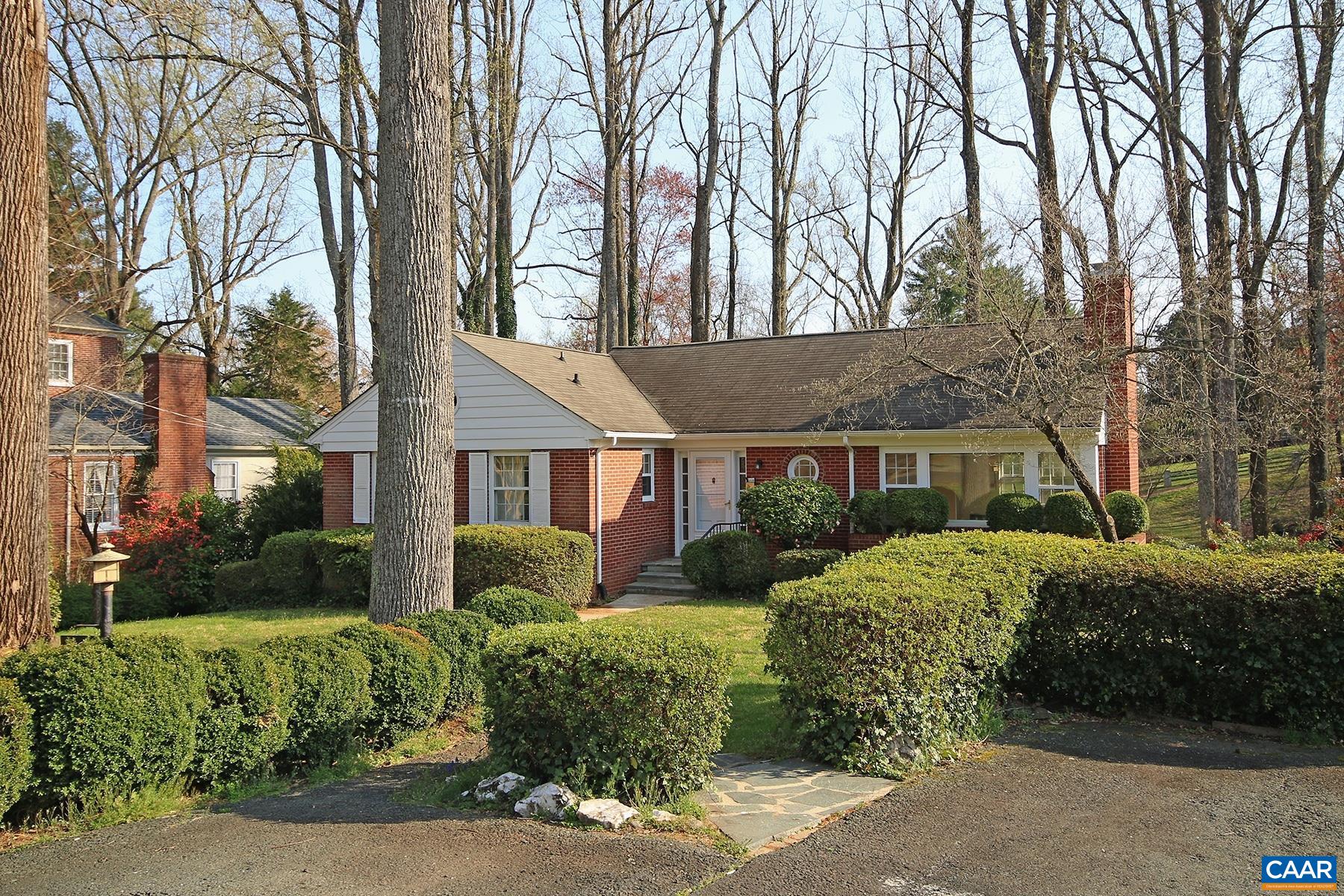 This charming 3 bedroom, 3 bath home is set within the desirable Lewis Mountain neighborhood and offers close proximity to the University of Virginia. Located within walking distance to Scott Stadium and UVA Aquatic and Fitness Center, and just a quick bike ride to UVA Medical Center. Also convenient to Rt 29, the 250 bypass, and I-64 plus UVA's North Grounds, and John Paul Jones Arena.   The 1,767 sqft home features 1950’s character and charm, light-filled spaces, hardwood floors throughout most of the main level, a walk-out basement with a mix of finished and unfinished spaces, and off-street parking.  The main level of the home includes a sunny living room with a brick fireplace, a dining room, a kitchen with white cabinets and appliances, plus the master bedroom with a private bath, and two additional bedrooms which share a hall bath. The walk-out basement includes a 4th bedroom option with tile flooring and a private bath, plus an additional room that would be perfect as a home office or craft room, and an unfinished area that includes the washer and dryer. Enjoy relaxing on the covered rear deck or lower covered patio area with park-like backyard views.