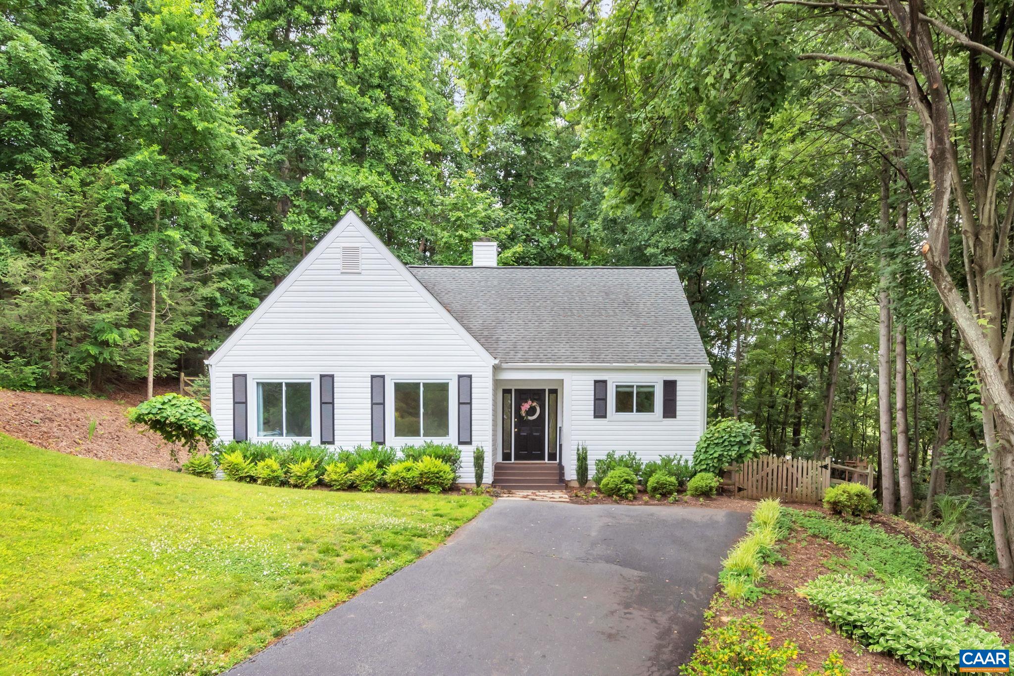 Open Saturday, 6/17 1-3PM! True one-level living and immaculately maintained cottage on a quiet cul-de-sac in amenity-rich Lake Reynovia just minutes to shopping, dining, and UVa/Downtown. This home lives large with a great room for living and dining with wood-burning fireplace, grand foyer, spacious kitchen, proper primary suite with walk-in closet & patio access, generous spare bedrooms and additional full hall bath. Set on nearly 1/3 of an acre with wooded privacy in the rear to enjoy the deck, patio, gorgeous landscaping, and fenced yard. Recent updates include new: windows, Trane Heat pump, kitchen door, Trex front porch, conditioned and encapsulated crawl space, all luxury lighting and fans, fresh paint, and landscaping. Plus, the roof, siding, hot water heater, and hardwood floors are new within 7 years. No carpet in this home. Move in time to enjoy the pool, tennis courts, and hiking trails all summer long!
