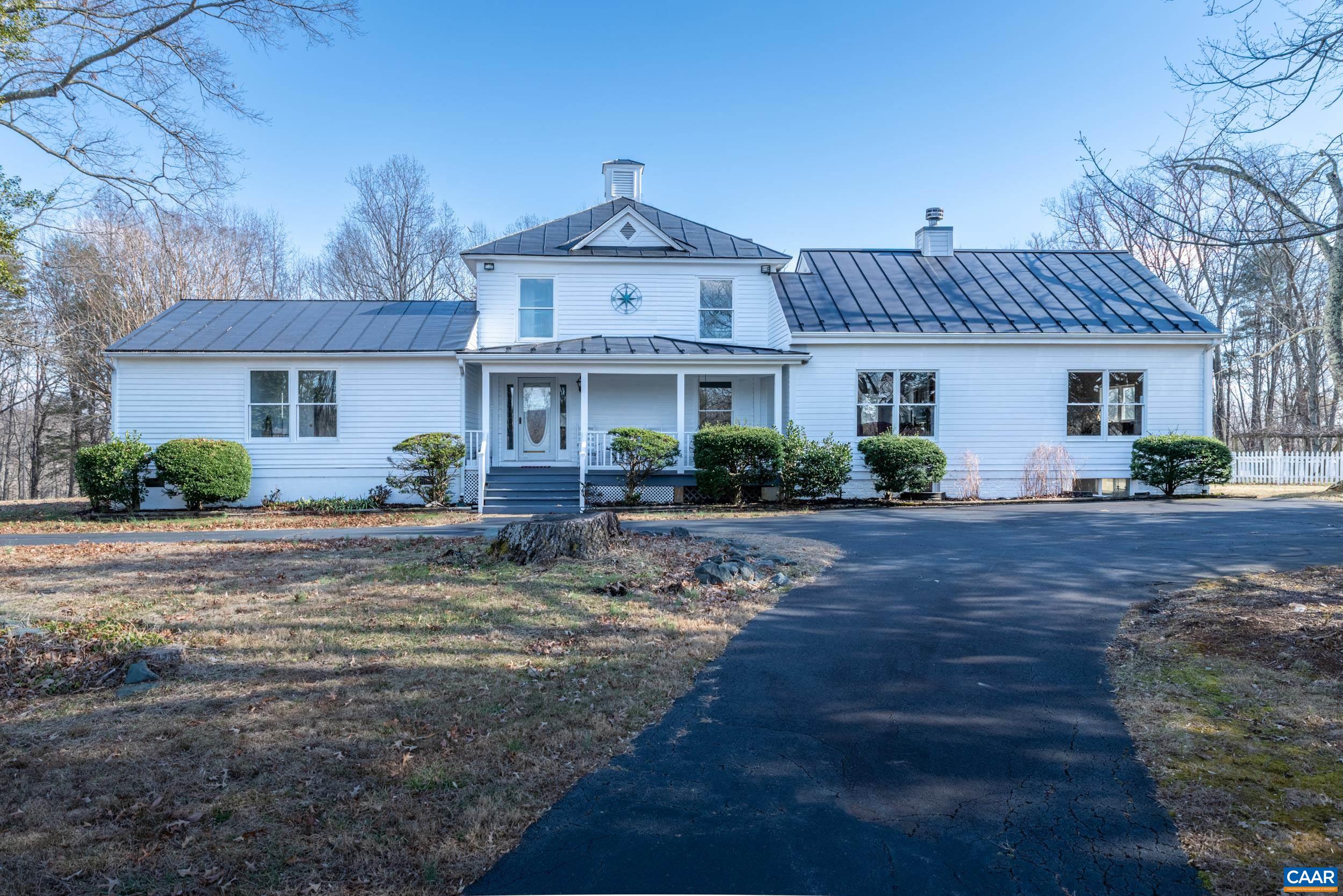 Lovely Country Estate to call Your Own! The original timeless portion is Circa 1861 with two tastefully added wings.  In 1970's a main floor Primary Bedroom Suite Wing was added.  This spacious suite with sitting area leads out to a private deck.  Primary Bath has shower and a jetted soaking tub for your pleasure. The handcrafted second wing (2000's) boost soaring Beamed Cathedral Ceilings above the Living Room and Family Room.  Snuggle up in front of the fireplace on those chilly days or for a romantic evening in the Living Room.  Moving thru to the Family Room, thru pocket doors, you find a generous area to utilize for gathering, music room, home office or whatever you imagine. Need more space????  Fully finished basement offers yet another area for Family Room, Craft Room, Man Cave, Home Office etc. Three separate but connected deck areas offer you outdoor living space perfect for Al-fresco dining and entertaining.   Relax on the spacious Front Porch with winter mountain views. Get your Outdoors on and stroll the trails of the wooded acreage. Four bay tandem garage with one bay as work area and one with back entrance for lawn equipment.  Just 20 minutes from Cville in Southern Albemarle County.  Possible division rights.
