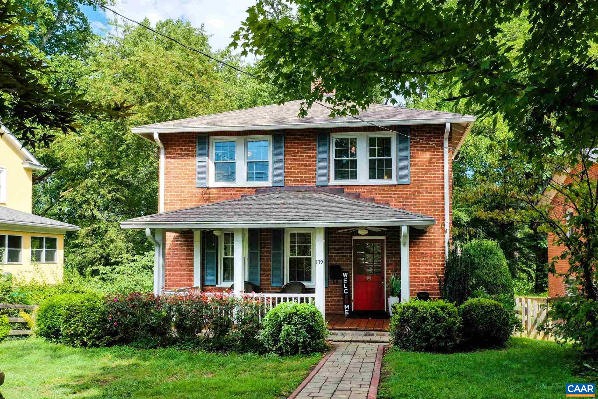 Don't miss this charming brick home on close to 1/2 acres in the Fry's Spring neighborhood. Walkable to Grounds in a charming and popular city neighborhood. The fabulous covered front porch is so welcoming and comfortable. Current homeowners have painted the entire interior, exterior trim, replaced all kitchen appliances, upgraded kitchen counters to granite and added new hardware! A big plus- this home is sited on a fantastic, flat yard that is fenced and backs up to a creek. Mature landscaping surrounding the home provides shade, privacy and beauty. You'll appreciate that this home has has been lovingly maintained by only two owners for the last 30+ years! Hardwood floors, original details and modern updates throughout make this home a rare find. The main level features a large living room with brick fireplace and built in shelving, a dining room, half bath and charming kitchen. Upstairs, three bedrooms each with hardwood floors and ceiling fans share TWO full bathrooms. Full walk-out basement is great for storage. Walk to UVA and Scott Stadium! Extra off street parking pad for 2 cars.