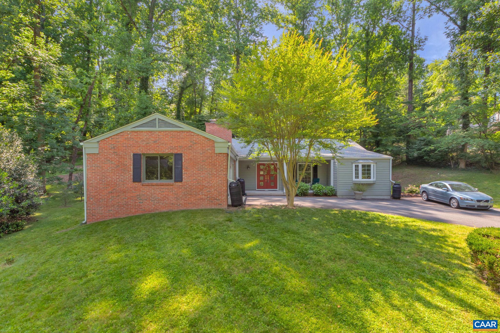 An incredible opportunity to own a ONE LEVEL, 2 CAR GARAGE home in the Greenbrier Neighborhood. Enjoy the Greenbrier Park (offering miles of trails along the Rivanna River) just steps from your front door. The home is open and inviting with hardwood floors and newer oversized windows. The kitchen has granite countertops and white, wooden cabinets. The family room is flex space that could be used in multiple ways: expand the kitchen, create a breakfast room, sitting area and more. You will love the brick, wood-burning fireplace. Located off the kitchen is a large (200sqft) sunroom with a wall of windows. The living room/dining room is open and spacious with easy access to the brick back patio. The primary bedroom offers hardwood flooring and an attached bathroom with tile flooring and a deep soaking tub. There is so much to love about this house. The location is perfect: headed to Whole Foods (walk) headed to Stonefield Shopping Center (walk). Easy access to Rt. 250, I64 and route 29.