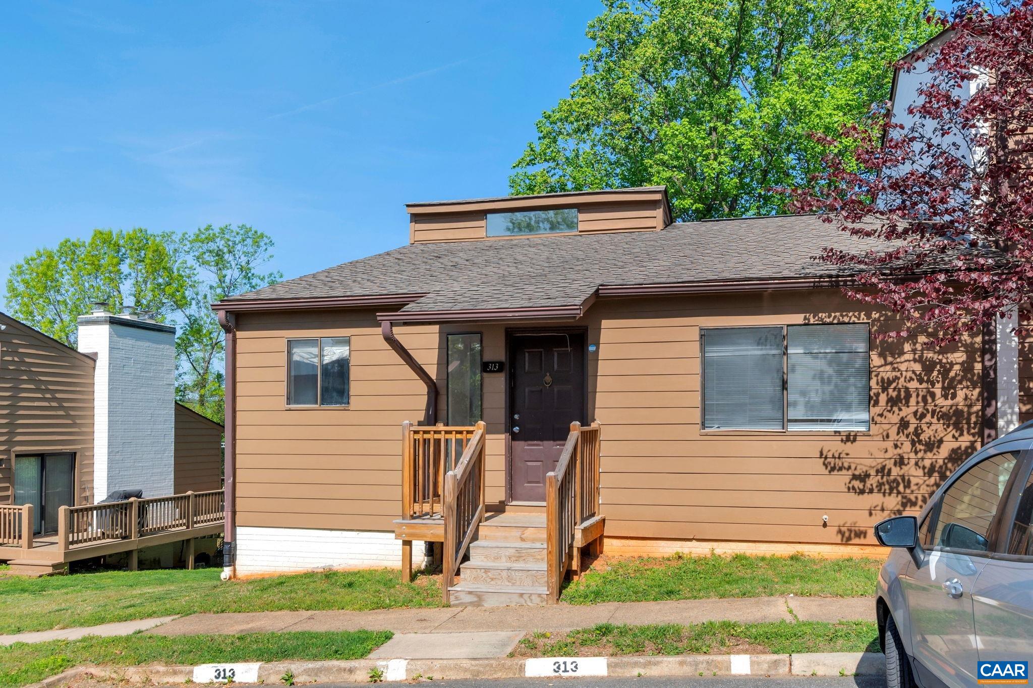 Great location near UVA Grounds, North Grounds, shopping and much more. Serious potential awaits in this end unit, which boasts first floor living, 2 bedrooms, 2 full bathrooms, vaulted ceiling, large rear deck, 2 wood burning fireplaces, and  unfinished walk-out basement for future expansion.