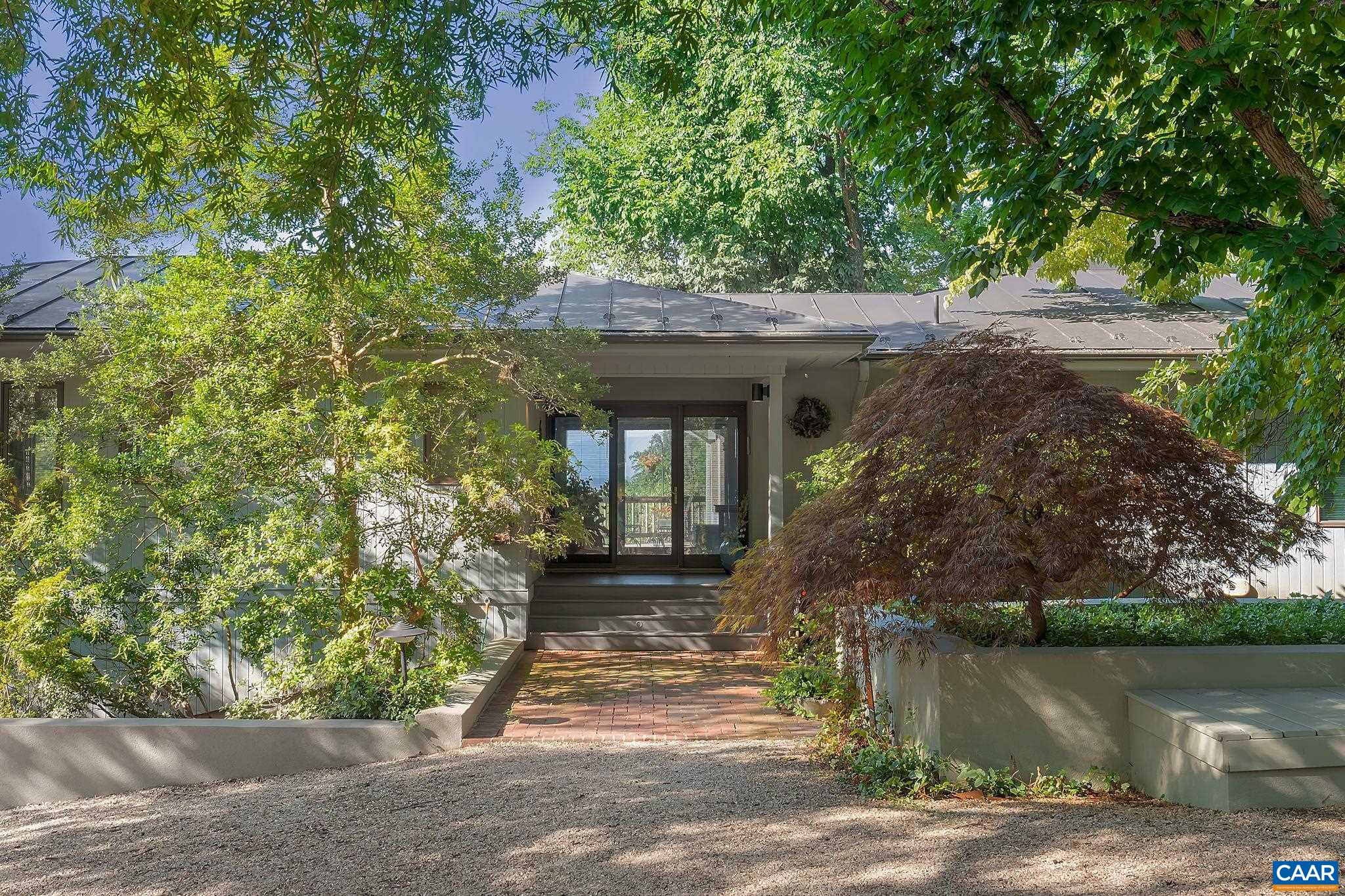 This is a beautiful, one-level contemporary home in a gorgeous setting with breath-taking mountain views nestled on 5.58 acres with one division right. This light-filled home has an open concept with plenty of room for folks to gather and lots of storage space. It is extremely well maintained and features wood floors, built-in shelves, two fireplaces, and a private and peaceful deck and patio. It also features skylights, whole-house generator, and lovely paths through the gardens.
