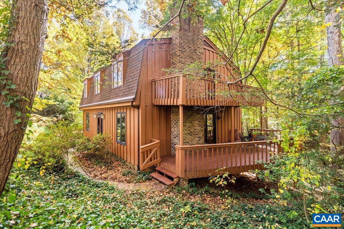 OPEN HOUSE SUN 2-4pm Don't miss the opportunity to live in this coveted Albemarle neighborhood so close to town. Located on the quiet end of a cul-de-sac around a green circle with lots of mature plantings, this property enjoys nice privacy. Large 1/3 acre lot joins with other large lots to form a valley of trees behind this home. From the back yard and from a deck off the den & an upper deck off the primary BR, look into a long view of dappled sunlight coming through the high canopy of large trees. There are lots of birds and a stream among the parklike woods here. Traditional colonial layout has 4 BRs all on the 2nd floor with large living spaces on the main floor. Large kitchen has original finishes all in good condition with a large breakfast room and ample pantry space. Two wood burning fireplaces, one in the den on the main level, one in the family room on the terrace level. Hardwood floors are in excellent condition. Lower level walks out to the back yard. Workshop/art studio on the lower level could be made into more bedrooms or office space with the addition of flooring. Only a 20 min walk to Barracks Road Shopping Center where you can find groceries, coffee shops, restaurants and services. Access to nice walking trails..