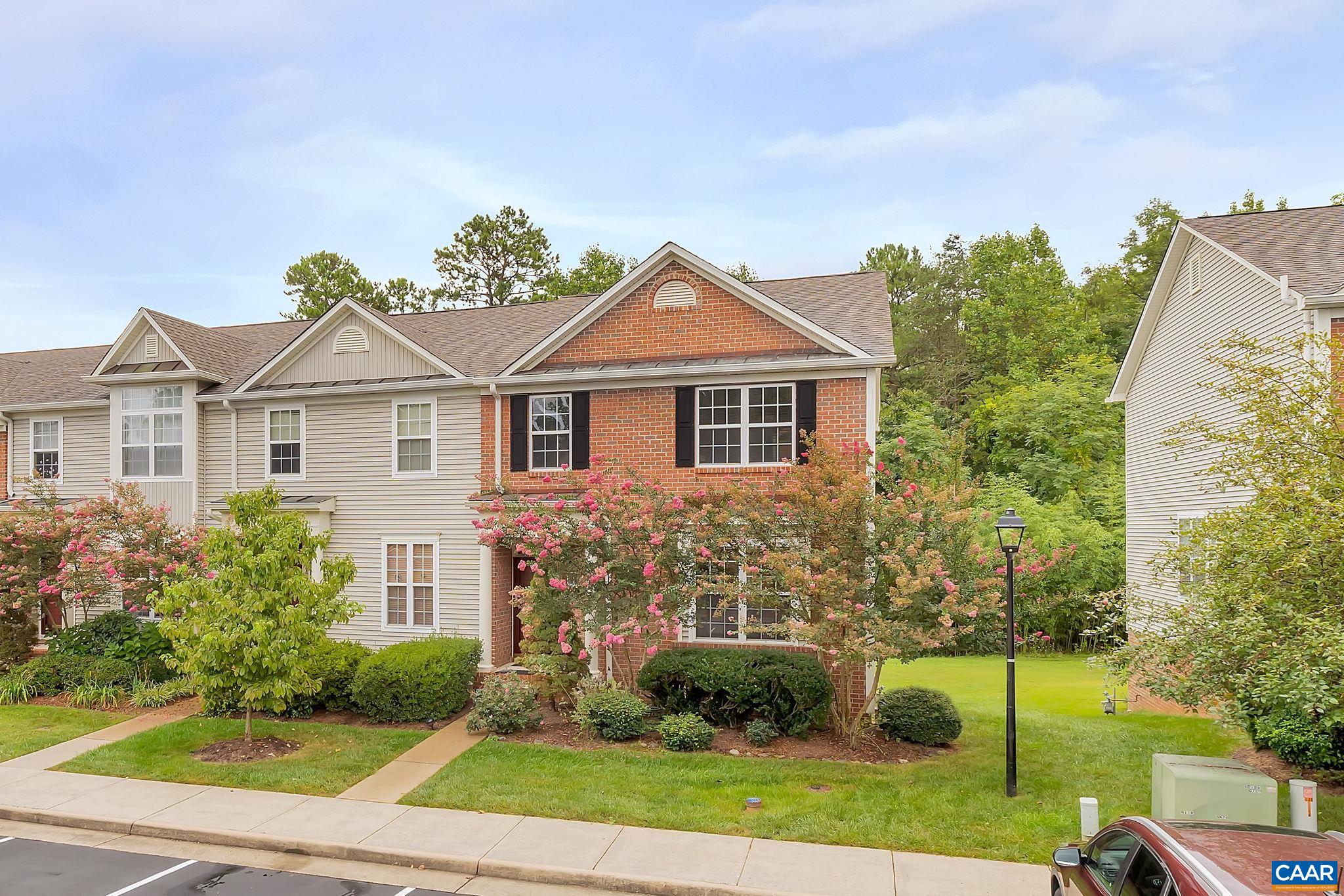 Welcome to this charming Hollymead two-story end unit townhome with a finished basement! The open floor plan bathes the space in natural light, showcasing beautiful hardwood floors. The living room's fireplace creates an ideal relaxation spot, and the spacious eat-in kitchen is perfect for both cooking and dining. Step onto the back deck for a serene wooded retreat. Upstairs, the master bedroom boasts vaulted ceilings, a roomy master bath, and a convenient walk-in closet. Two more bedrooms and a full bath provide additional space. The finished walk-out basement is great for guests or as a private sanctuary, featuring an extra bedroom, recreational room, and full bathroom. Minutes from Hollymead Town Center, dining, and the Charlottesville airport, this neighborhood offers scenic walking trails and lakes. The HOA includes pool access, a play area, yard maintenance, and trash pickup. Updates include a new HVAC system, water heater (2021), and a new deck (2023).