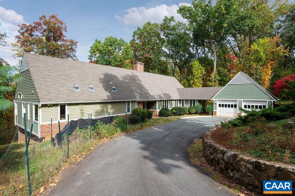 Rare opportunity to acquire an expansive, custom, unique Ivy home for an unheard-of price. Bring this gem back to life & make it your own! The quaint exterior belies a light filled interior w/walls of glass & a wonderful balance of open, entertaining rooms & cozy everyday spaces. Floorplans in docs. The grand living room will WOW you & flows into an oversized dining room & a serene “gallery”. You'll love the large eat-in-kitchen with a huge island, two pantries & super built-ins in the adjacent breakfast room. The nearby mudroom connects to the driveway & garage for easy unloading. The main floor owners suite, added in 2006, has floor to ceiling windows overlooking woods w/potential Blue Ridge views. The spa-like primary bathroom pairs with a separate soaking tub & amazing dressing room for luxury living. Take the elevator or lovely open staircase to the terrace level to enjoy 2 large bedrooms, each w/a renovated bathroom, plus a family room w/FP, wet bar, large outdoor deck & 3 more bonus spaces for you to use as you wish! All this on 1.3 acres in the welcoming Peacock Hill neighborhood, with tennis courts, playground, walking trails & community lake; Western Schools, close to I64 & 250 for an easy drive into Cville.