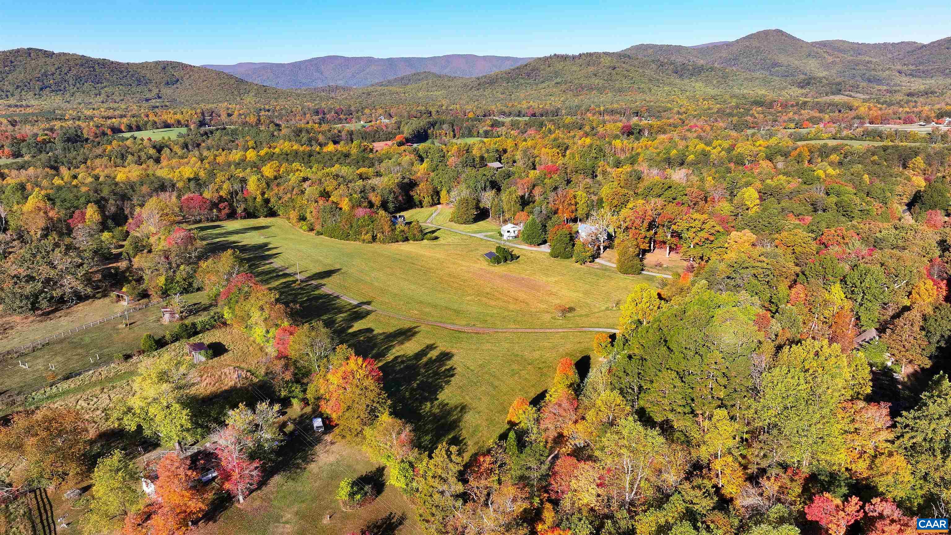 A BUY OF A LIFETIME IN THE HEART OF HUNT COUNTRY! Timeless 1916 Virginia farmhouse blends classic styling & modern convenience on 55+ acres in beloved Free Union! Leave the world behind & bask in privacy, picturesque views, & impressive income potential within 20 minutes of Charlottesville. Delight in the cozy & quiet elegance of generously-sized rooms, a versatile floor plan offering one-level living, a workhorse farm kitchen, and a glorious great room for gatherings or quietude. With four bedrooms, a home office, & three full baths, there's plenty of space for everyone. Move-in ready w/potential for future updates and expansion. Accommodate guests, renters, or multigenerational living in the 2 additional cottages. Enjoy endless possibilities w/ no conservation easement & division rights! Embrace off-grid living options w/  solar, whole house generator, wood stoves, & a well hand pump. Bring your horses, creative, conservation & gardening pursuits! Don't miss this extraordinary opportunity to live in harmony with nature in the best of Albemarle!