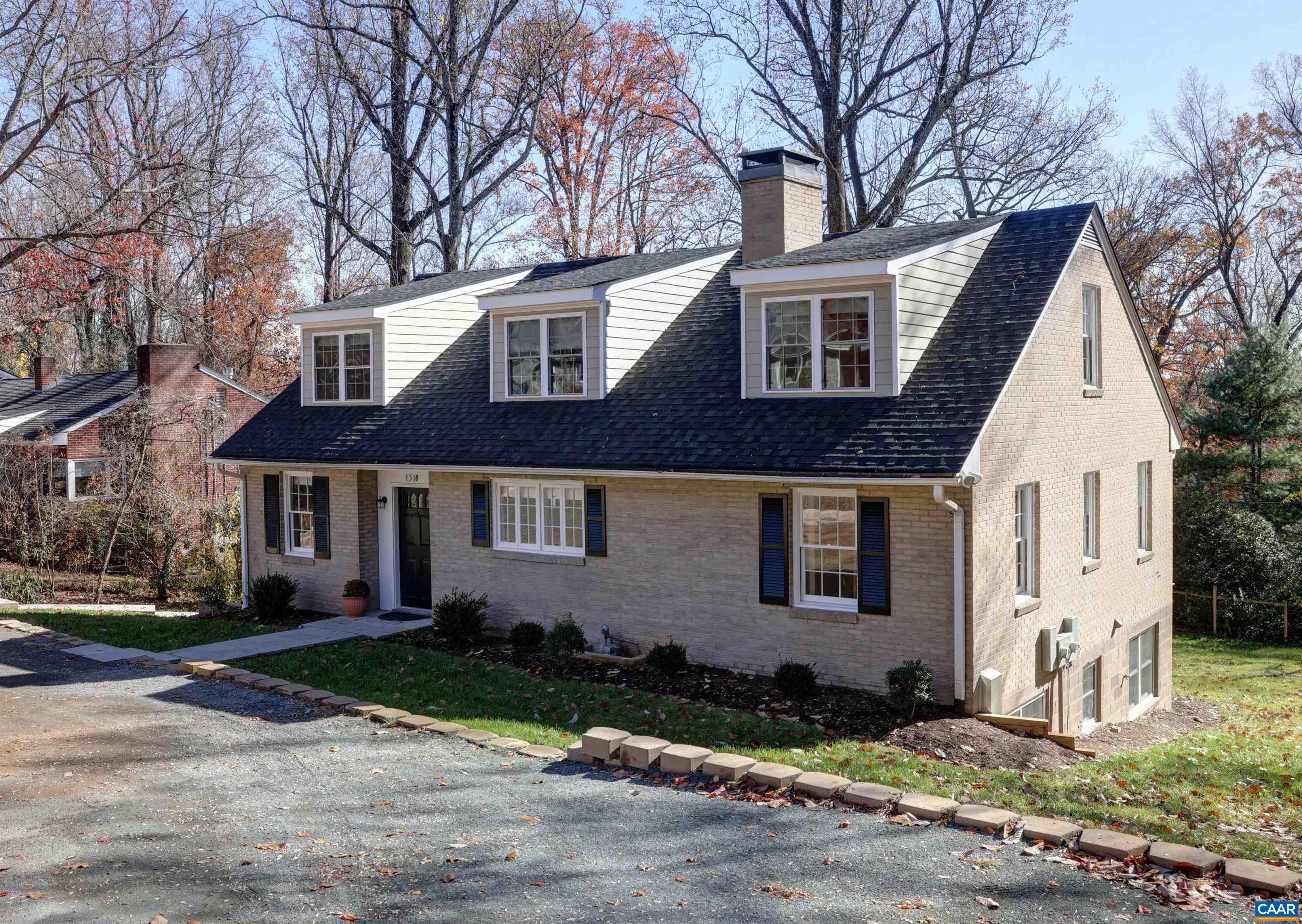 DAIRY ROAD - Expansive brick mid-century modern home that has been lovingly renovated with all new systems and conveniently located in one of the City's most desirable residential neighborhoods. Enter the main floor with open living room with fireplace, dining area, flowing into the spacious cook's kitchen, home office/library, primary bedroom & bath and half bath. The rear of the main level has a covered porch.  Enter the upstairs to huge open space with flexible uses along with two bedrooms and full bath. The lower level is a separate fully equiped lving space along with two bedrooms each with a private bath and a home office. Many upgraded features such as wood floors on the main two levels & cedar closet in primary bedroom. Great light throughout. Easy access with a large circular drive in the front. The large rear yard is so private. Within minutes of all the City and UVA amenities.