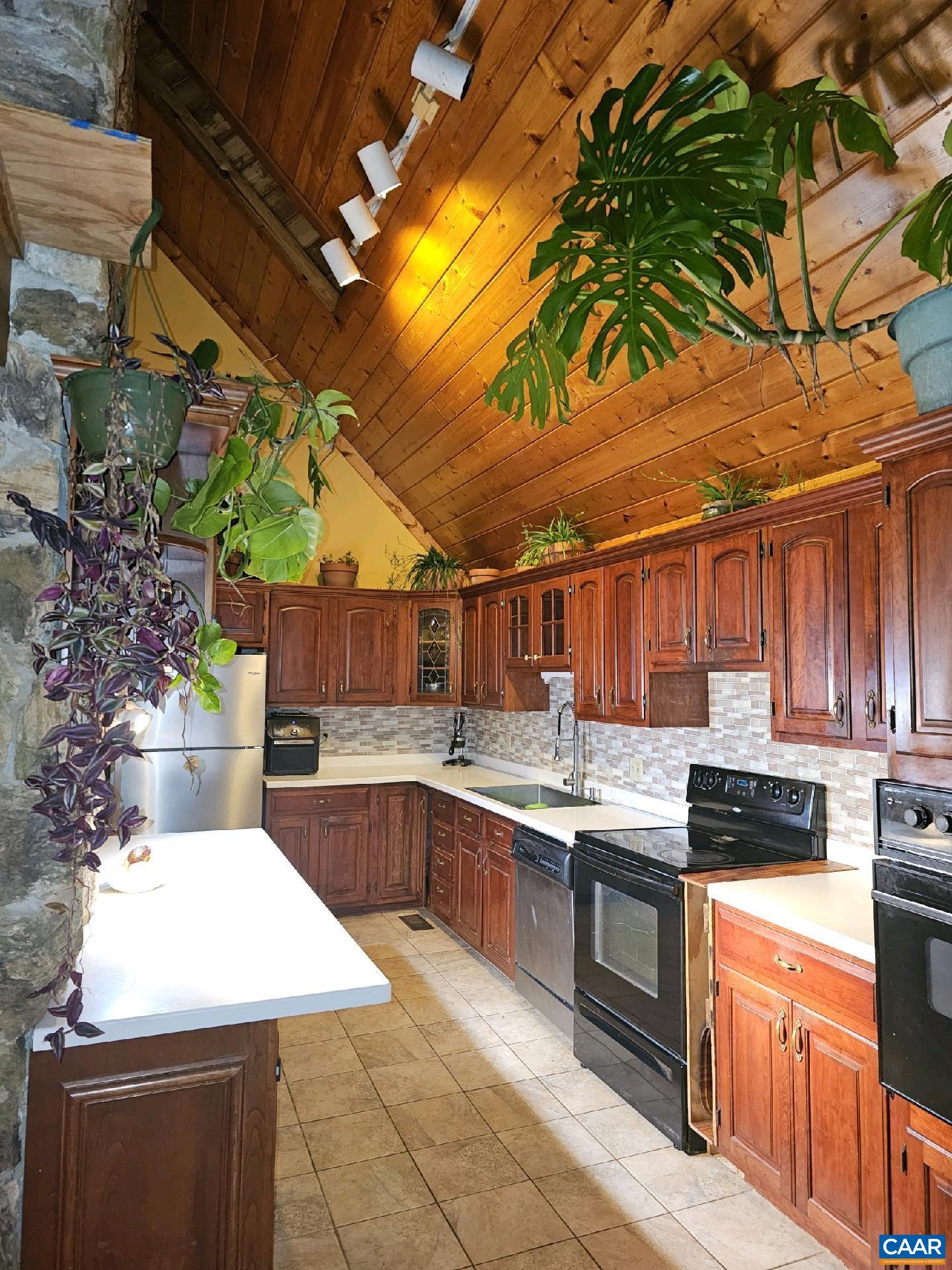 New Well Pressure Tank (1 of 2).  Newly Painted!  Beautiful, serene, private, mountaintop chalet boasting mountain view with 1500 sq. ft. of decking!  3 story propane fireplaces featuring a triple floor rock chimney. Upper bedroom(3)/studio/great room with loft, closets, and fireplace.  ALL bedrooms lead to private balconies. Plenty of Storage. 2 gardens totaling at least 1500 sq. ft. One garden is set up as a chicken run with coop and automatic door. Goldenrod, Astor, Blackberries, Black Raspberries, Blueberries. New Roof in 2009. HOA $200/yr. Road Maintenance. Closest house in Swann Ridge Estates to state maintained road. 1 mile stroll to a Natural Spring, 100 ft. off the Blue Ridge Pkwy(exit 99), 5 mi to The Appalachian Trail, 3 mi to Hump Back Rocks, 20 mi to Wintergreen, 2 mi from I64, 6 mi to Waynesboro, 20 mi to Sherando Lake, and 25 mi to Charlottesville.