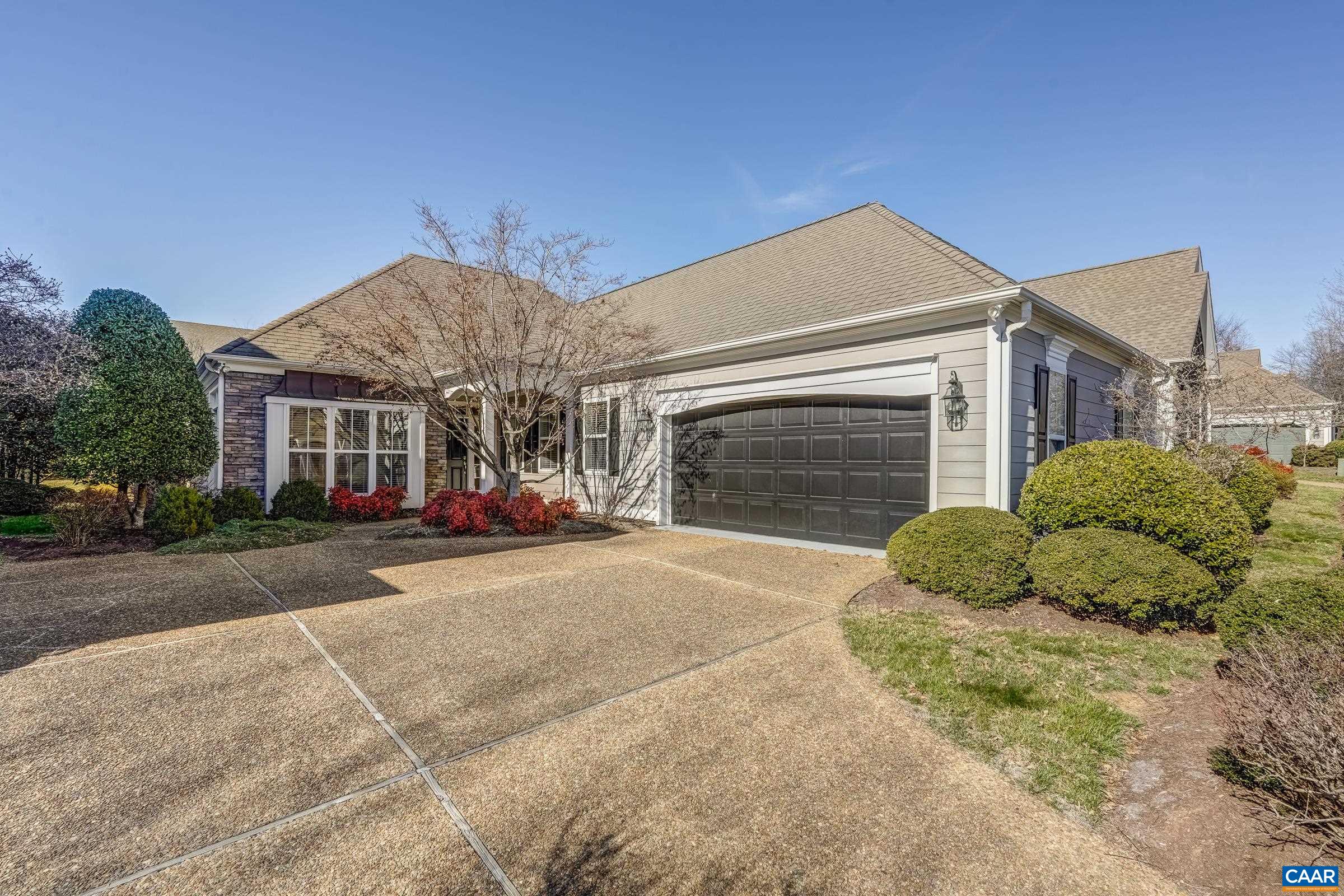 Enjoy convenient one level living in the Stone Gate Community of Western Ridge. Cathedral ceilings accentuate an attractive living room that connects with the sun room that share a double sided gas fireplace. The primary bedroom has floor to ceiling windows, tray ceiling and spacious private bath. The kitchen has ample maple cabinetry for storage, center island, eating bar and a recent upgrade for the appliances. The laundry room contains full size washer & dryer and large utility sink.   Additional storage is available in the walk-up attic that can also be finished at a later date. You will appreciate that landscaping & exterior painting are covered by the HOA!