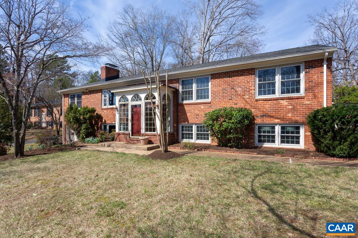 Tucked away on the hilltop in the middle of a double cul-de-sac, 2323 Glenn Court is a charming 4 bed 3 bath home in one of Charlottesville’s most sought-after neighborhoods. This modified Greenbrier split-level checks every box and features numerous updates throughout. The expanded front entry offers flexible foyer/mudroom styling options and leads to a lovely open living room with wood burning fireplace. There is a private office off the open kitchen/dining room and an inviting sunroom that provides additional entertaining space and indoor/outdoor flow. The main level also includes the primary bedroom with en-suite bath plus 2 additional bedrooms that share a full bath. Downstairs features a cozy family room with big windows, wood burning fireplace & built-in shelves/cabinets. This expansive lower level includes an additional guest bed, full bath, dedicated laundry room, unfinished storage area and garage access. Classic mid-century appeal, a beautiful private setting make this a truly special property. The elevated lot offers all day sunlight and a commanding view of the neighborhood while open backyard backs up to a private road. Convenient to everything, walking distance to Greenbrier Elementary & the Rivanna Trail System.