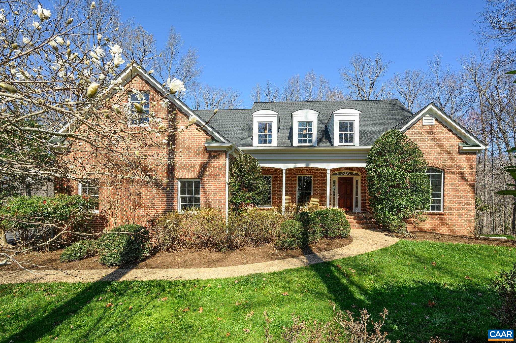 This expansive Ivy home, pristinely maintained, has a super blend of open & private spaces for great flexibility & flow. A welcoming, traditional brick facade belies an updated interior vibe for a quietly impressive home with no pretension.The main level has a formal living & dining rooms, family room w/vaulted ceilings, built-ins & fireplace & overlooks a new deck & sunny backyard. No homes in sight to the rear: the owners enjoy hiking the woods to the Mechums River. The generous kitchen is truly at the center of the home w/oodles of cabinetry, counter space, walk-in pantry & oversized breakfast area. Off the kitchen is a sunroom (ideal for playroom or home office). A back hall leads to additional closets, laundry room, back stairs, garage & side entry. The main level primary suite is tucked away & the spa-like bath is in a quiet corner overlooking the rear yard. Upstairs find 3 enormous bedrooms, all w/walk in closets, one has an en suite bathroom & the other two share a jack & jill, & a huge bonus room for teen space, play/craft/gym: whatever you need! Finally, 2500+ sf of unfinished basement w/rough-in bath is ALL potential: dream away!  Minutes to Ivy Elem, Rt 250 or Barracks Road for the drive into Cville or Crozet.