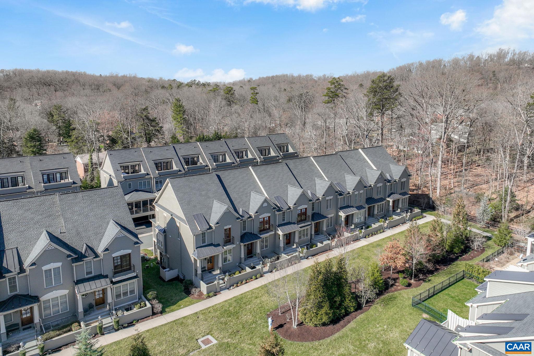 NEW PRICE! Welcome to luxury living at its finest in this exquisite townhome conveniently located near UVA in "Out of Bounds" - a quaint community with easy in/out access via stoplight at Barracks Road. Experience the perfect blend of elegance and convenience as this home was meticulously crafted and every detail thoughtfully designed to provide the ideal amount of space - indoors and out. Upon entering, you will immediately notice the high-end finishes and stunning architectural details throughout the home. The stone fireplace adds handsome character plus the beautiful built-ins on every floor provide the perfect spot to display or store your treasures. The spacious and sunlit rooms create a warm and inviting atmosphere ideal for entertaining or relaxing. You'll love the convenience of a flexible floor plan which adapts to your lifestyle, along with the added luxury of an elevator for easy access to all levels. Indulge in outdoor living during all four seasons with a screened porch featuring gas fireplace which offers a tranquil retreat, as well as a top floor suite with kitchenette & rooftop deck providing panoramic views of the surrounding area. The 2 car, rear facing garage is smart and well planned for maximum curb appeal.