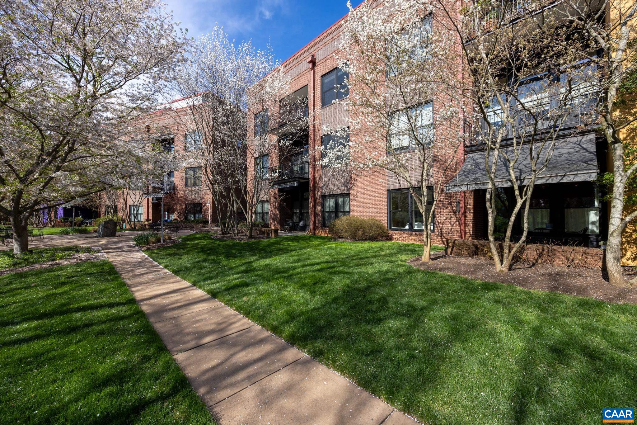 Note new price please. Wonderful first floor condo on park side with easy access to private gardens and all that the Belmont Lofts have to offer outside. So many upgrades since 2017: new heat pump, tankless water heater, windows, gas fireplace, custom closet, building roof etc.  See documents section for complete list. Indoor parking in reserved location with lockable storage area for additional storage.