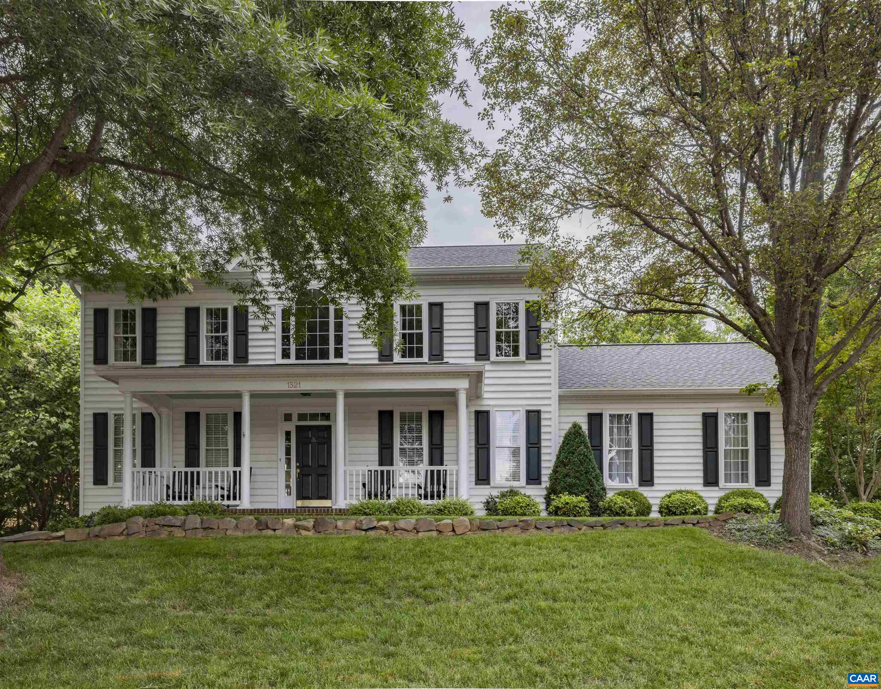 This elegant, light-filled home boasts a wonderful floor plan designed for living and entertaining inside and out! Gleaming hardwood floors throughout the main and upper levels enhance the home's timeless charm. A large office at the front of the home features French doors for added privacy. The formal dining room is perfect for easy entertaining. The great room includes a gas fireplace with a stone surround and custom arched window, opening to the breakfast nook and spacious kitchen. The high-end kitchen features cherry cabinets, quartz countertops and handmade coordinating wall tile. Designer appliances include a Brizo faucet and a GE Monogram suite with a dual fuel professional range, counter-depth refrigerator and dishwasher with custom cherry paneling. The kitchen also boasts a large center island for food preparation and informal gatherings, as well as a separate custom cherry hutch. Upstairs, the primary suite features a custom walk-in closet and a remodeled ensuite bathroom. Three additional bedrooms on the upper level all feature large closets and fans.  Walk-out terrace level features rec room, fifth bedroom, full bath and storage! All this plus lush private yard, expansive deck and oversized garage with storage above.
