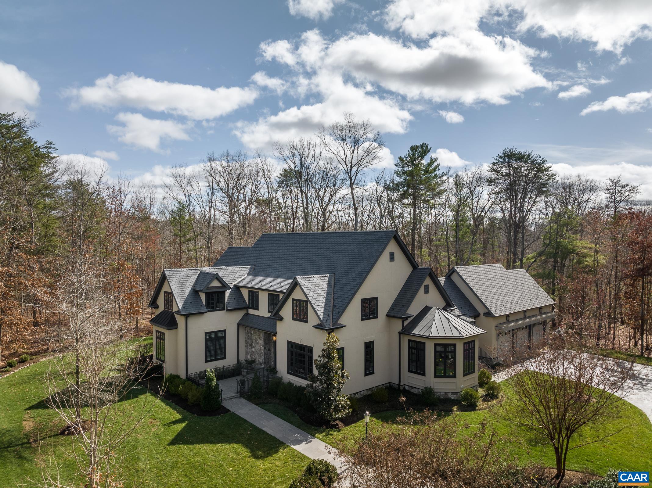 Exquisite French Provincial masterpiece offering luxury and comfort! The finest in custom finishes throughout this architectural gem!  Enjoy the best of main-level living with sumptuous primary suite, adjacent study with fireplace, two spacious walk-ins with custom shelving, and private access to the bluestone patio. Recently and completely renovated gourmet kitchen will satisfy the most discerning chef and features top-of-the line appliances, custom cabinetry, and exceptionally crafted details. Relax in the soaring great room with beamed vaulted ceilings & stone fireplace or flow effortlessly out the French doors to the trellised bluestone patio. Entertain in the sun-drenched dining room or enjoy intimate dining or lounging in the semi-octagonal conservatory/breakfast room. Thoughtfully designed mud room, laundry room, and desk/workspace complete the main level. Three additional bedrooms upstairs, each with attached full baths and ample storage areas. Second floor loft overlooks the great room and is an ideal workout room or private work area. The gardens and outdoor spaces are immaculate and perfectly manicured. New solar, whole house generator, heated exterior bluestone walkway/front entryway and so much more! Must see!