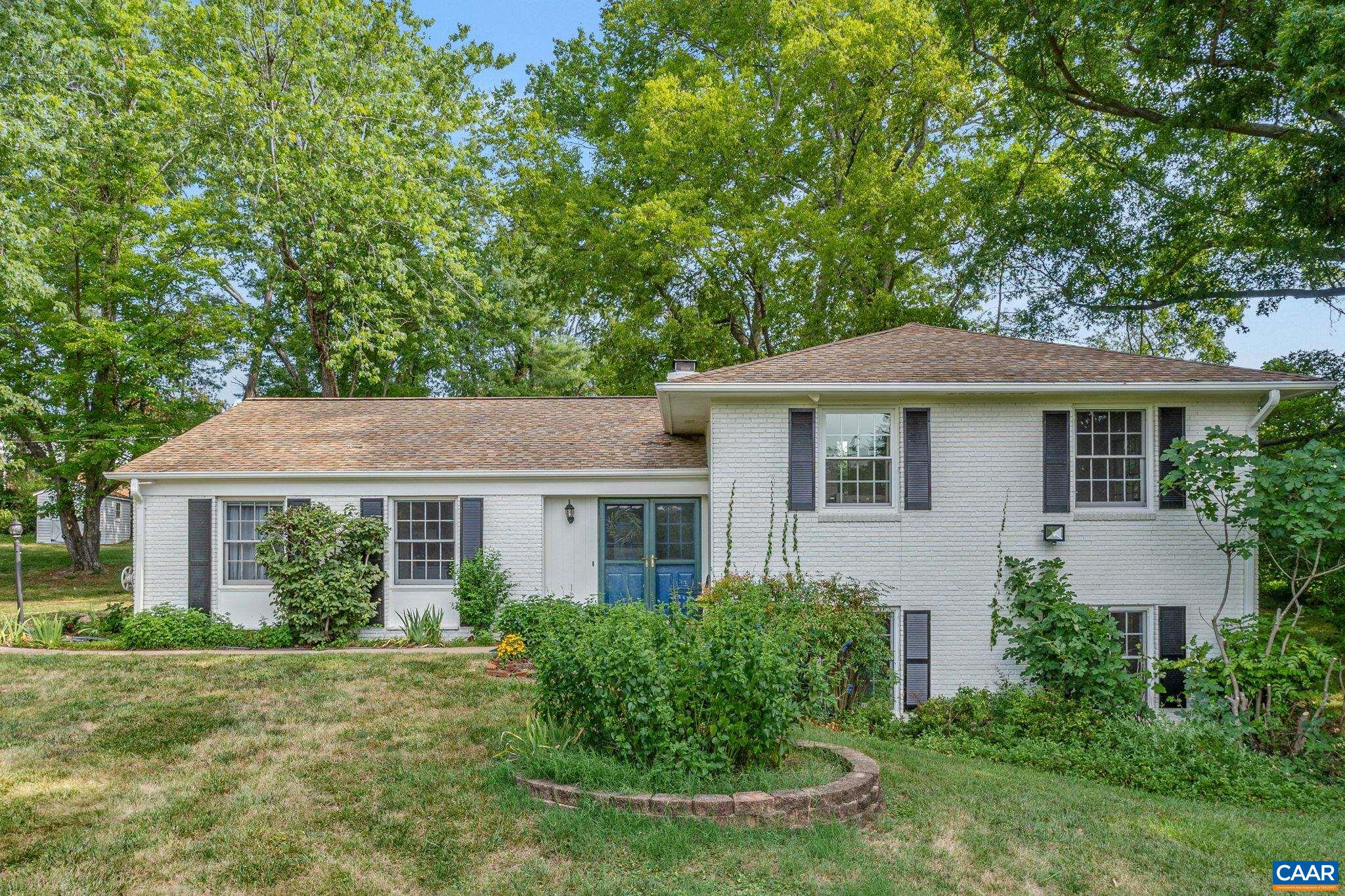 Well-maintained home in Key West Neighborhood just minutes to downtown Charlottesville. A long driveway lined with dogwood trees leads you to this beautiful split-level home. The house has a cozy kitchen with Italian terra cotta tile, a formal, beautifully wallpapered dining room,  & a large living room with a tropical-themed wallpaper accent wall, windows facing the patio, & a wood-burning brick fireplace. Upstairs a master suite, plus 2 bedrooms & a full bathroom. On the fully finished lower level there is a family room with a wood stove, bedroom, full bath & laundry room. The private lot features a spacious, park-like 1.77 acres & the rear blue stone patio is shaded by large trees. A gardener's paradise: beautiful fenced-in garden (800 sq feet) w/ raised cedar beds & its own garden shed. Established fruit trees: cherry, apple, plum, paw paw, & persimmon. Second shed for storage & the lower level is configured with a plug for a generator w/ Honda portable generator. The whole house benefits from an infrared air purifier. Optional membership to the Key West neighborhood pool & club. Recent upgrades - exterior & interior painting 2024, conditioned crawl space 2024, mini splits on lower level 2022.