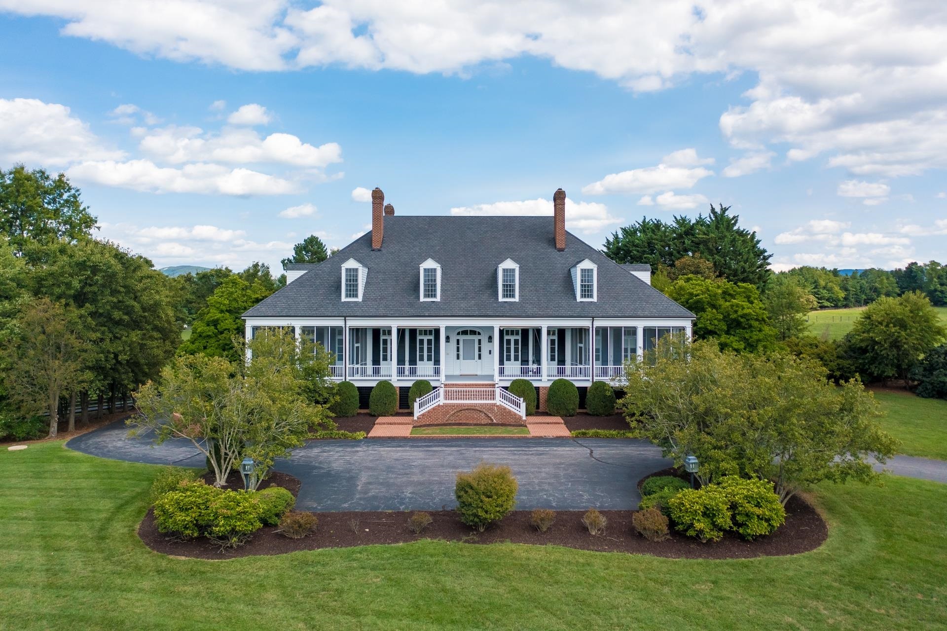 Willow Pond Farm is a gracious southern home of approximately 11,000 sq ft of finished living space situated on over 69 acres in the countryside of Augusta County. This stately custom built home exemplifies quality craftmanship throughout. The home offers oversized formal and informal living spaces washed in natural light. Once through the front door admire the cherry floors, high ceilings. large moldings, and attention to detail. The kitchen is well equipped with a sub-zero refrigerator, double oven, cooktop on the island and loads of beautiful custom cabinets. Unload your groceries onto the elevator located off the garage and then directly into the large walk in pantry with beautiful wood shelving. The expansive front porch sets the stage for picturesque pastoral, pond and mountain views. Relax on one of the three screened porches or down by the salt water pool. The property is complete with a chicken coop, playhouse, a large bank barn, an equipment shed and a 3-bay building.
