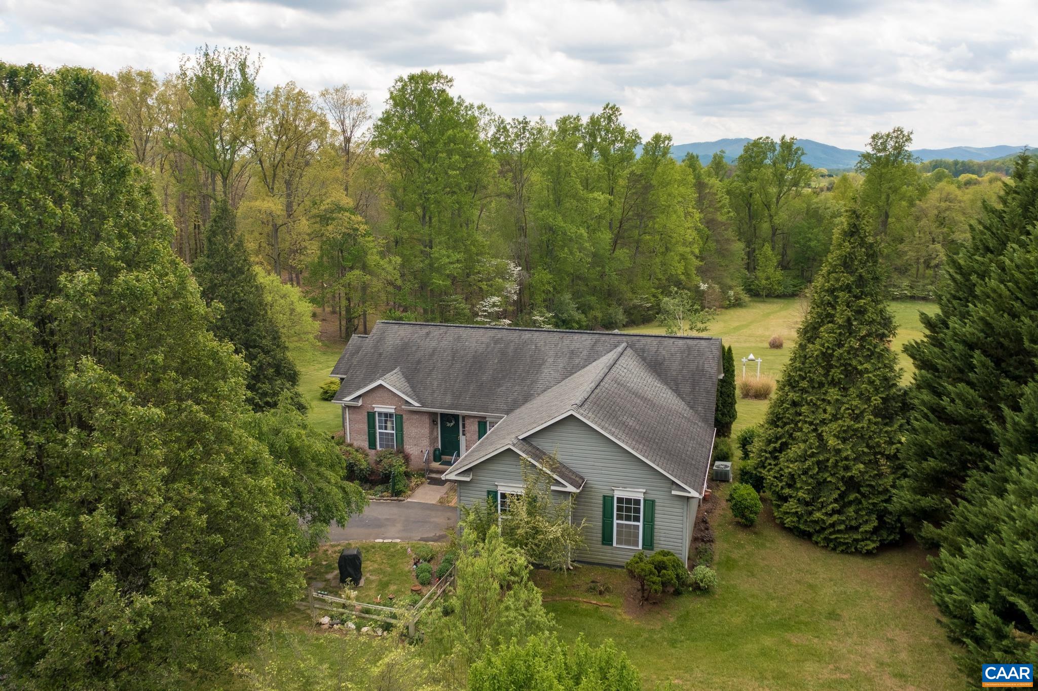 One level living in the heart of Afton with Mountain Views!  Situated on over 2 acres this home offers an open living room, sun room, three bedrooms and 2 baths.  Split bedroom floor plan for maximum privacy in the primary suite.  Attached one car garage with bonus area (originally part of the garage. Could be converted back to garage space if wanted.)  Land is gently rolling and offers sunny spaces for gardening and more! Conveniently located just off 151 and minutes to Nelson 151 attractions!