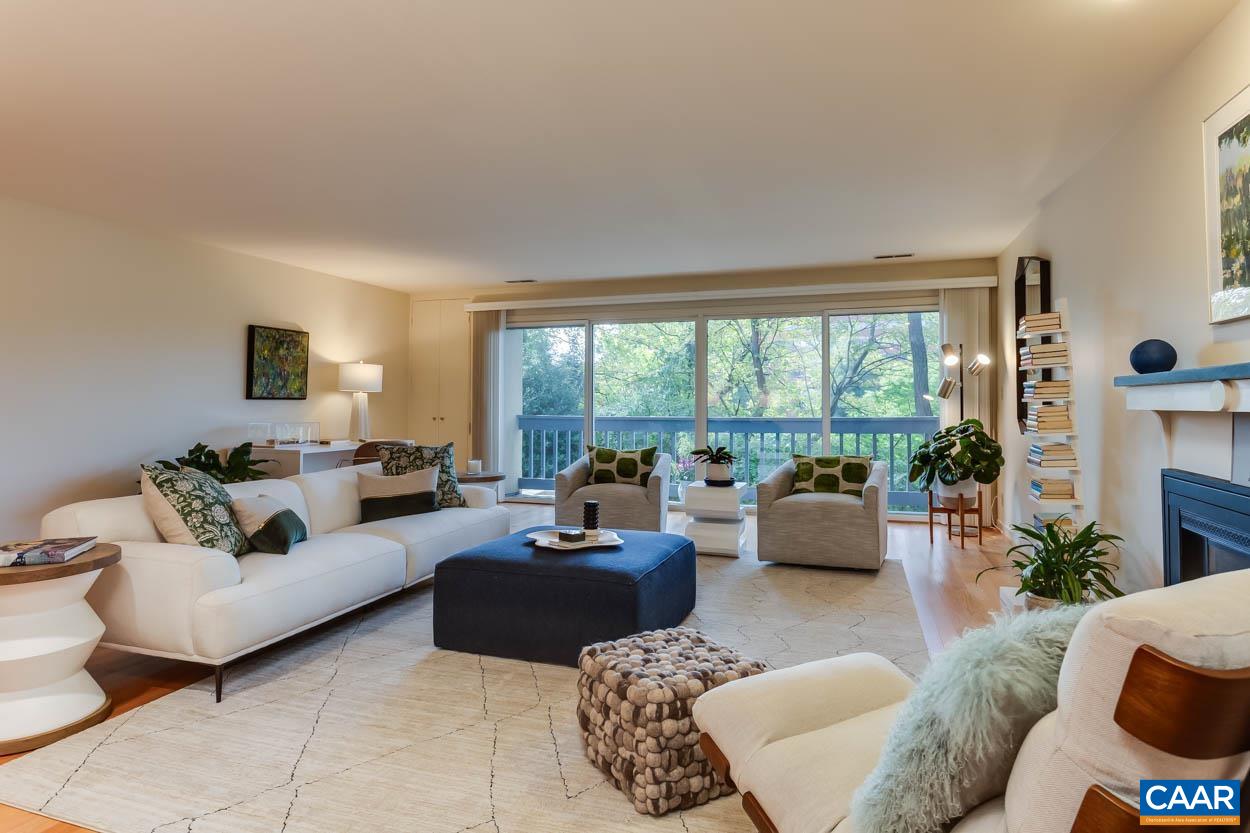 Discover a true oasis in the heart of the city! This exceptional McGuffey condo offers the perfect blend of seclusion and downtown living. Featuring two generous bedrooms and two full bathrooms, this spacious unit boasts elegant hardwood floors, a cozy wood-burning fireplace, and expansive floor-to-ceiling windows or sliding glass doors in nearly every room, ensuring an abundance of natural light. Den with built in bookshelves could also serve as a third bedroom. Recently installed (2 years old) wood floors throughout all the entertaining and living spaces. One level living. Enjoy serene moments on your private patio—ideal for sipping your favorite beverage or diving into a good book. Incredible location within walking distance to the Downtown Mall. Dedicated covered parking. Don’t miss the opportunity to make this tranquil haven your own!