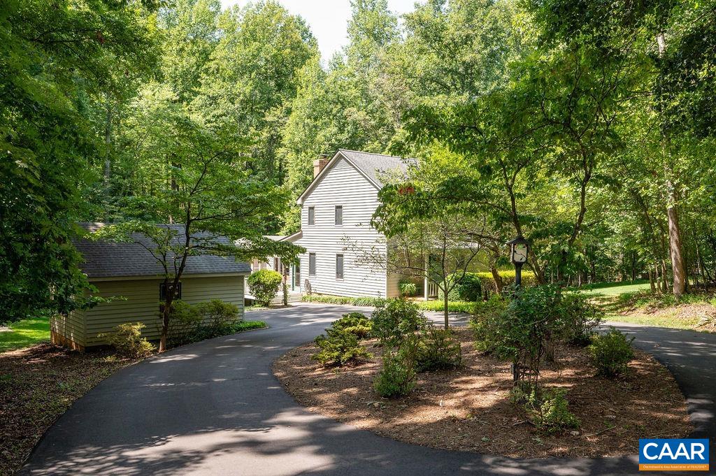A charming and well-maintained home privately tucked off Owensville Road in the sought after neighborhood of Whippoorwill Hollow. Situated on two acres, this oasis is protected by mature trees yet offers plenty of yard to garden, to play, and/or to simply enjoy nature. The welcoming circular driveway is complemented by a detached garage with a concrete sport court behind. Inside, an open kitchen flows seamlessly into a breakfast nook with French doors that lead to an expansive and welcoming screened porch. A cozy living room features a wood burning fireplace with an adjacent dining room. A bedroom, currently used as a home office, and a full bath complete the main floor. The second floor hosts a primary bedroom suite, along with two additional bedrooms and a full bath. All bathrooms were remodeled in 2020, along with new exterior paint, new carpet, and additional paint inside. Please see associated documents for details on renovation and maintenance over the years, including a 16kW generator. A wonderful offering in the heart of the western school district and less than ten miles to most everything Charlottesville.